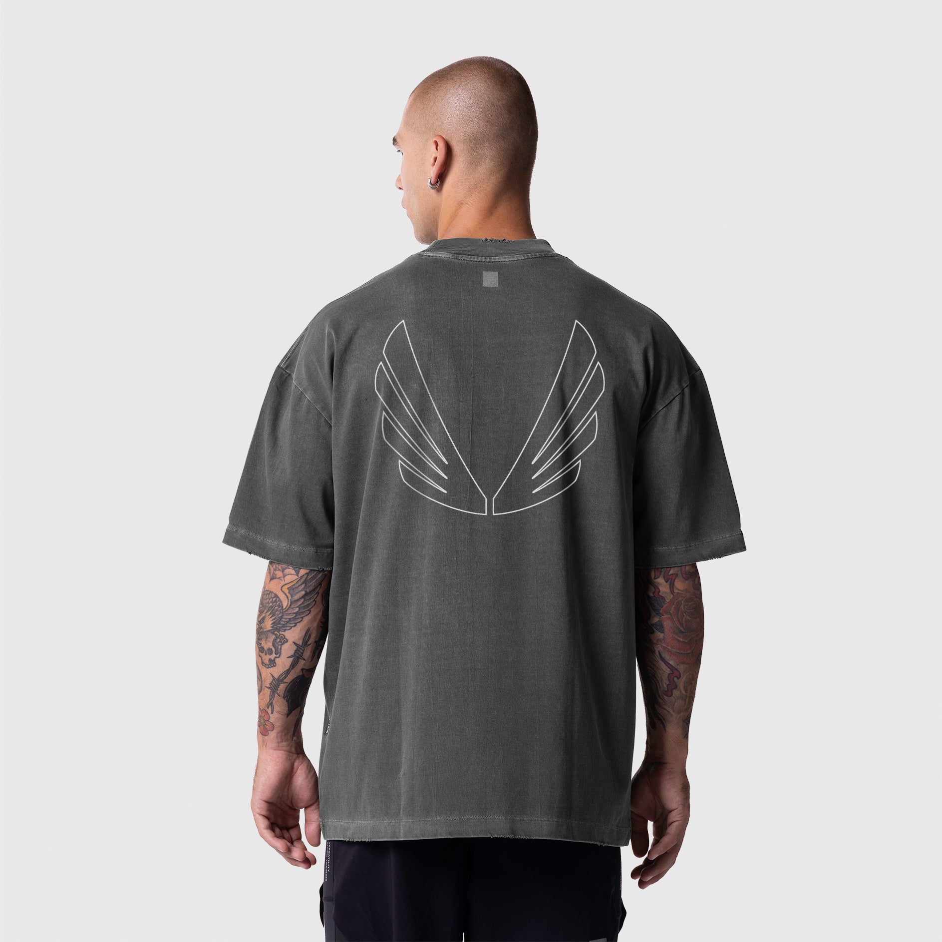 Model wearing ASRV Tech Essential Oversized Boxy Tee in Faded Grey with Future wings graphic on back.