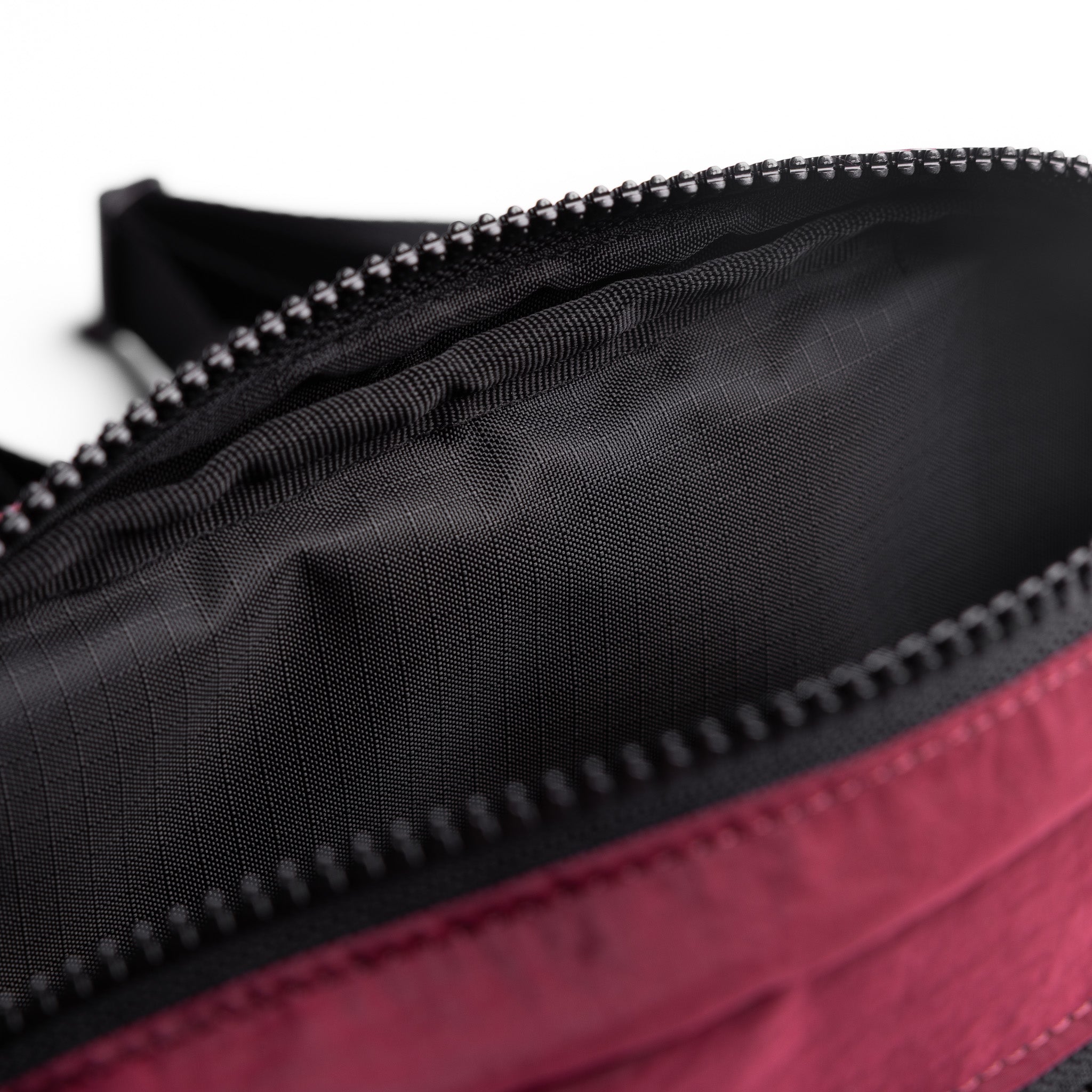 Flatlay 1231 Ripstop Crossbody Bag in Crimson, detail closeup of zipper
