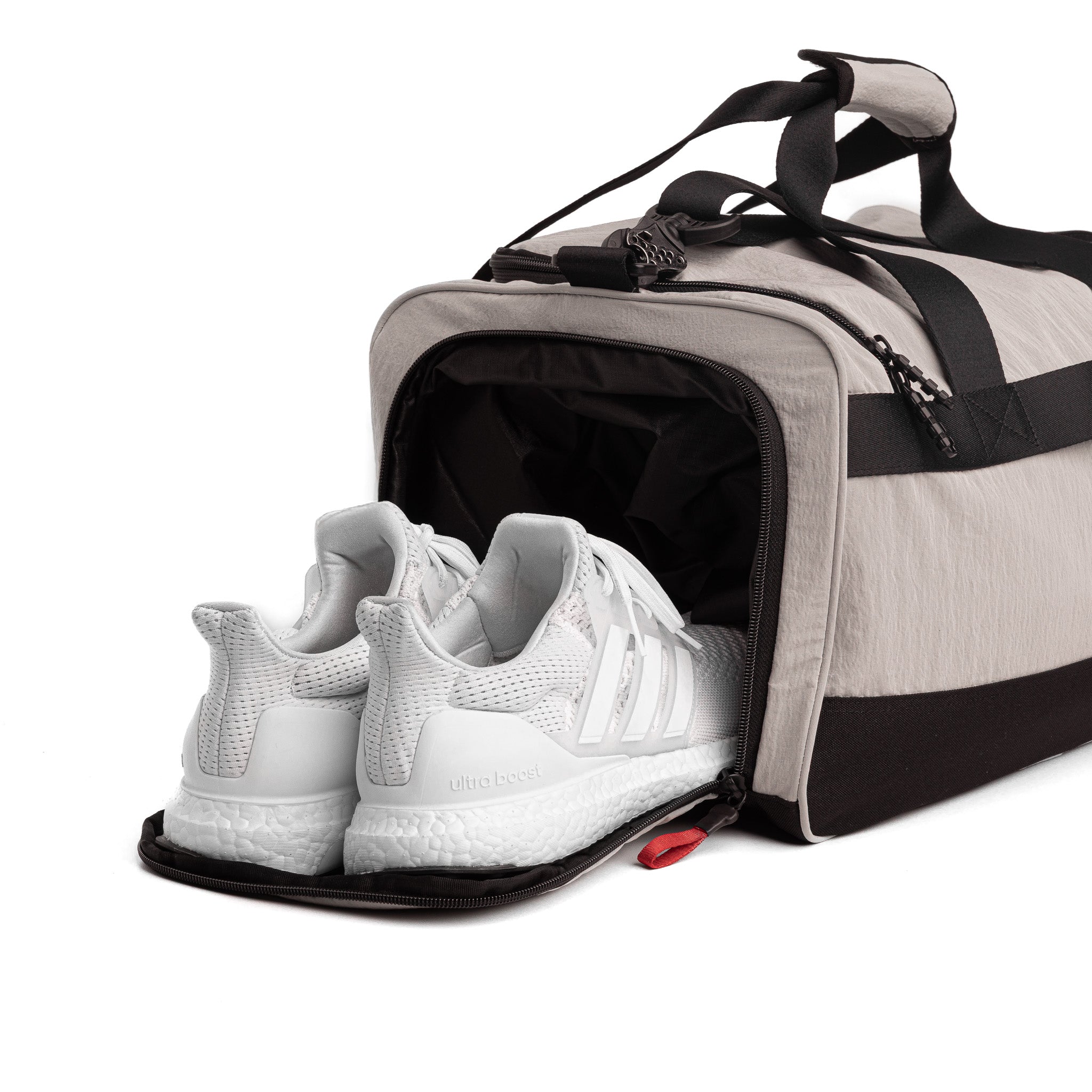Flatlay 1234 Ripstop Duffle Bag in Chai with white sneakers in shoe compartment