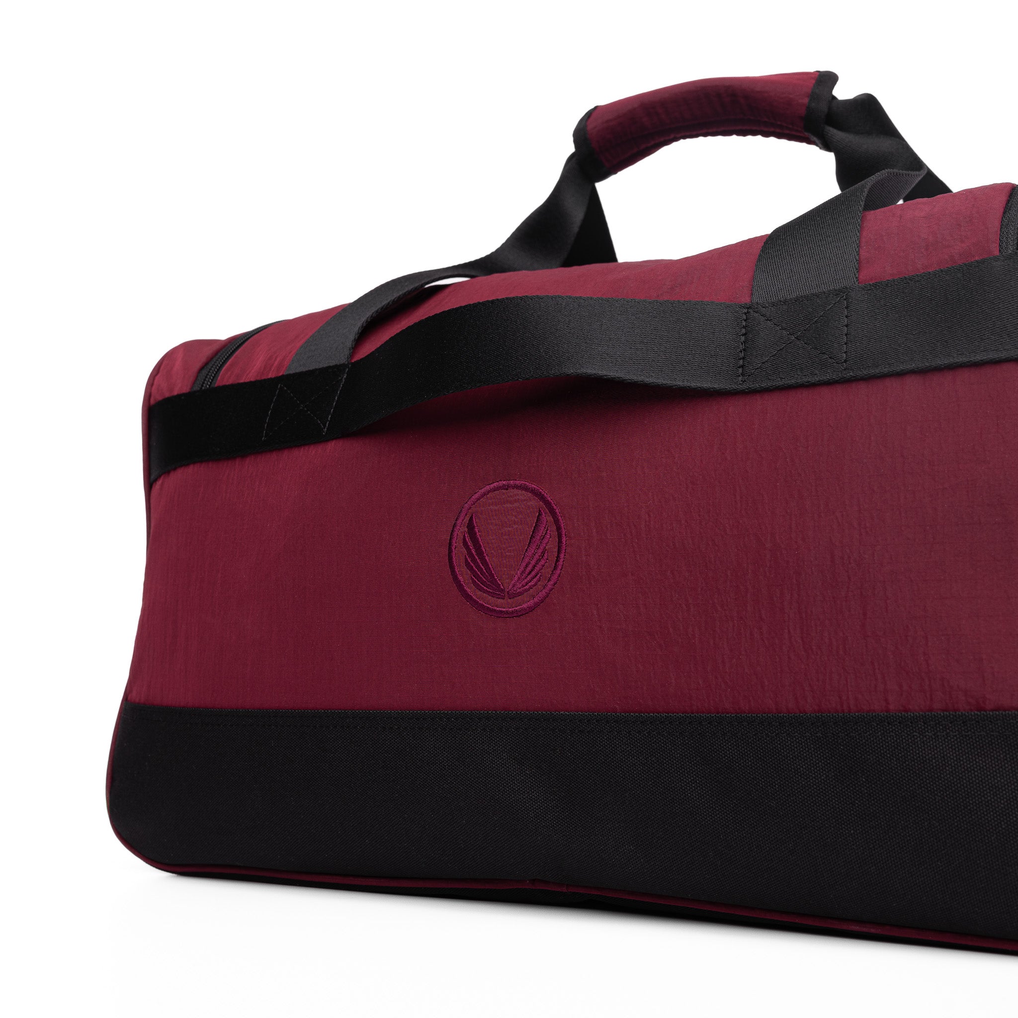 Flatlay 1234 Ripstop Duffle Bag in crimson and black, angled view