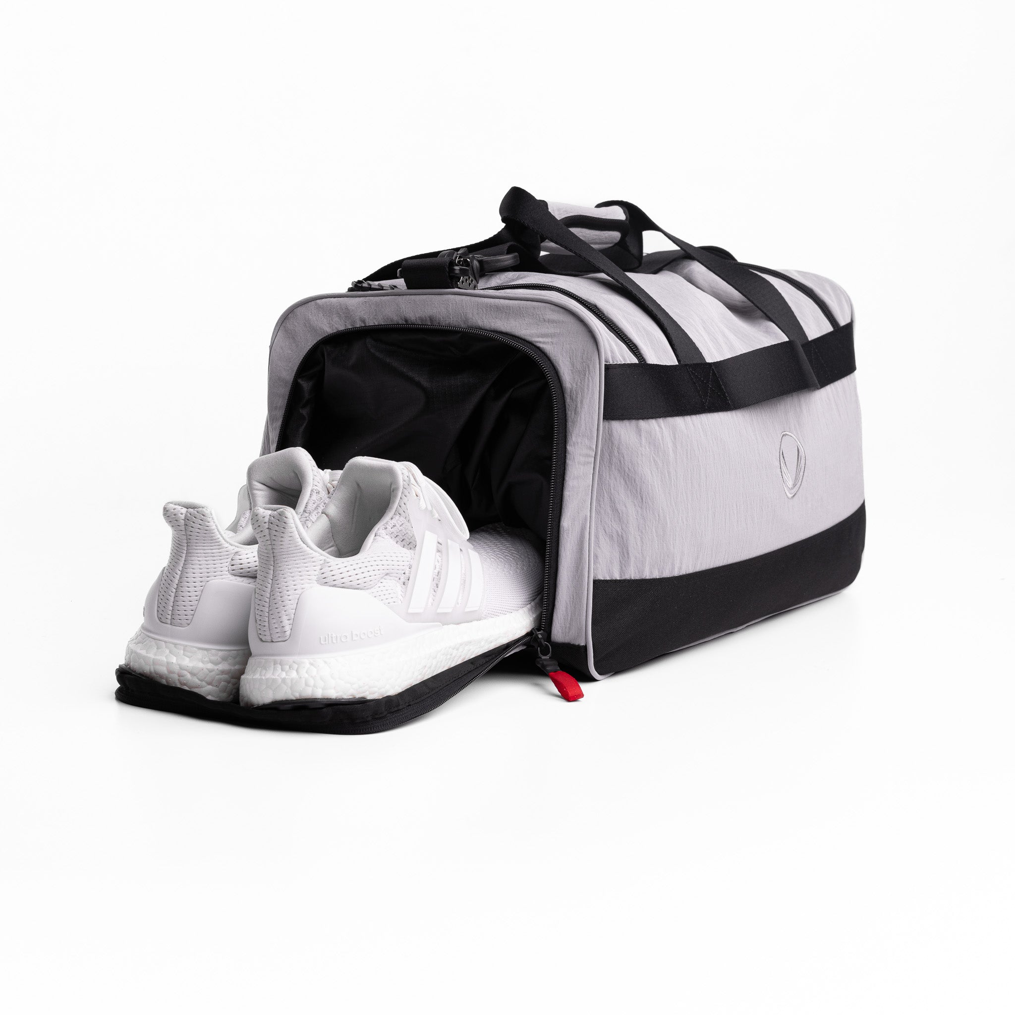 Flatlay 1234 Ripstop Duffle Bag in slate grey and black, open with white sneaker inside