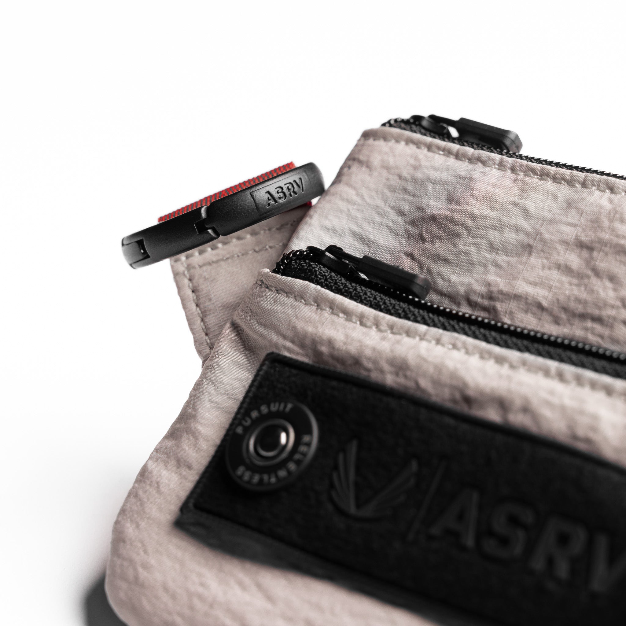 Flatlay of 1235 Ripstop Clip Bag in Chai, detail view with zipper and logo visible