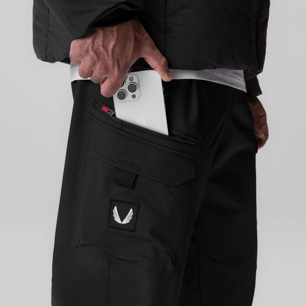 Black Tetra Weather-Ready City Pant worn by model, demonstrating cargo pocket with phone storage