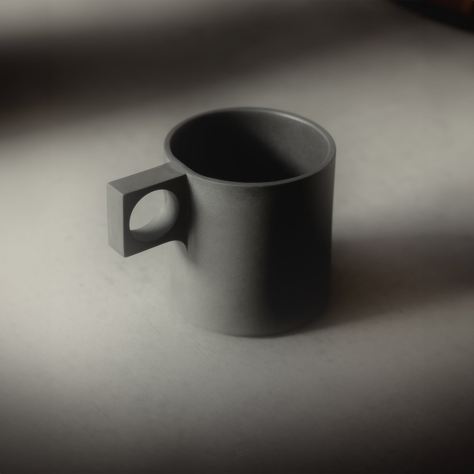 ASRV x Walden ceramic mug in charcoal grey, angled view