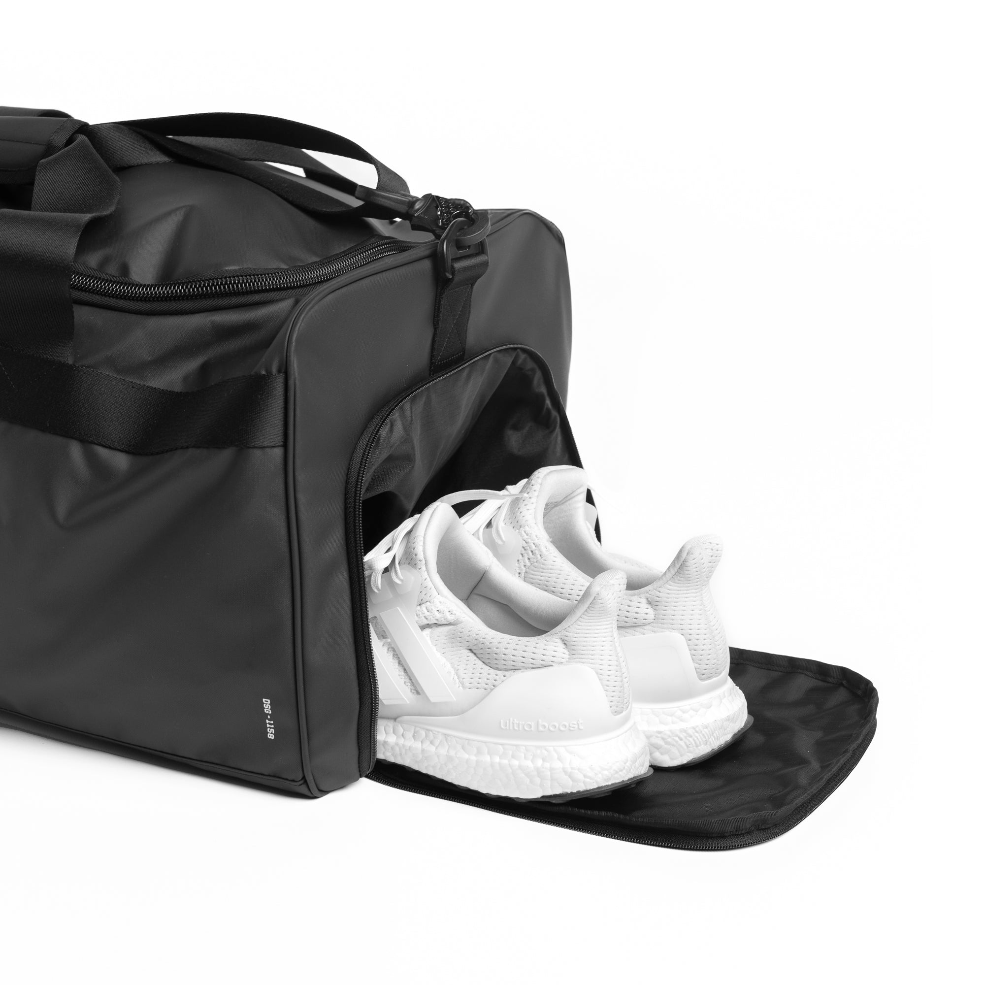 Flatlay Water Resistant Duffle Bag 55L in black with white sneakers