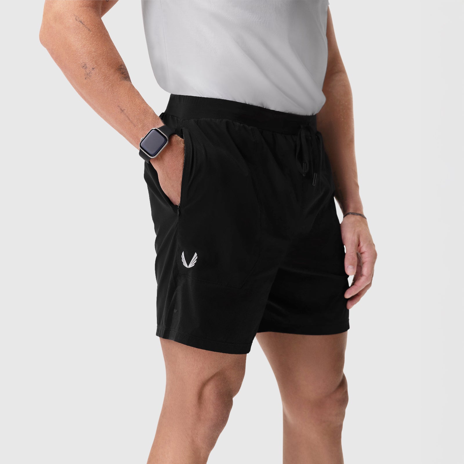 Aerotex Training Short in black, modeled on man wearing white tee, side view