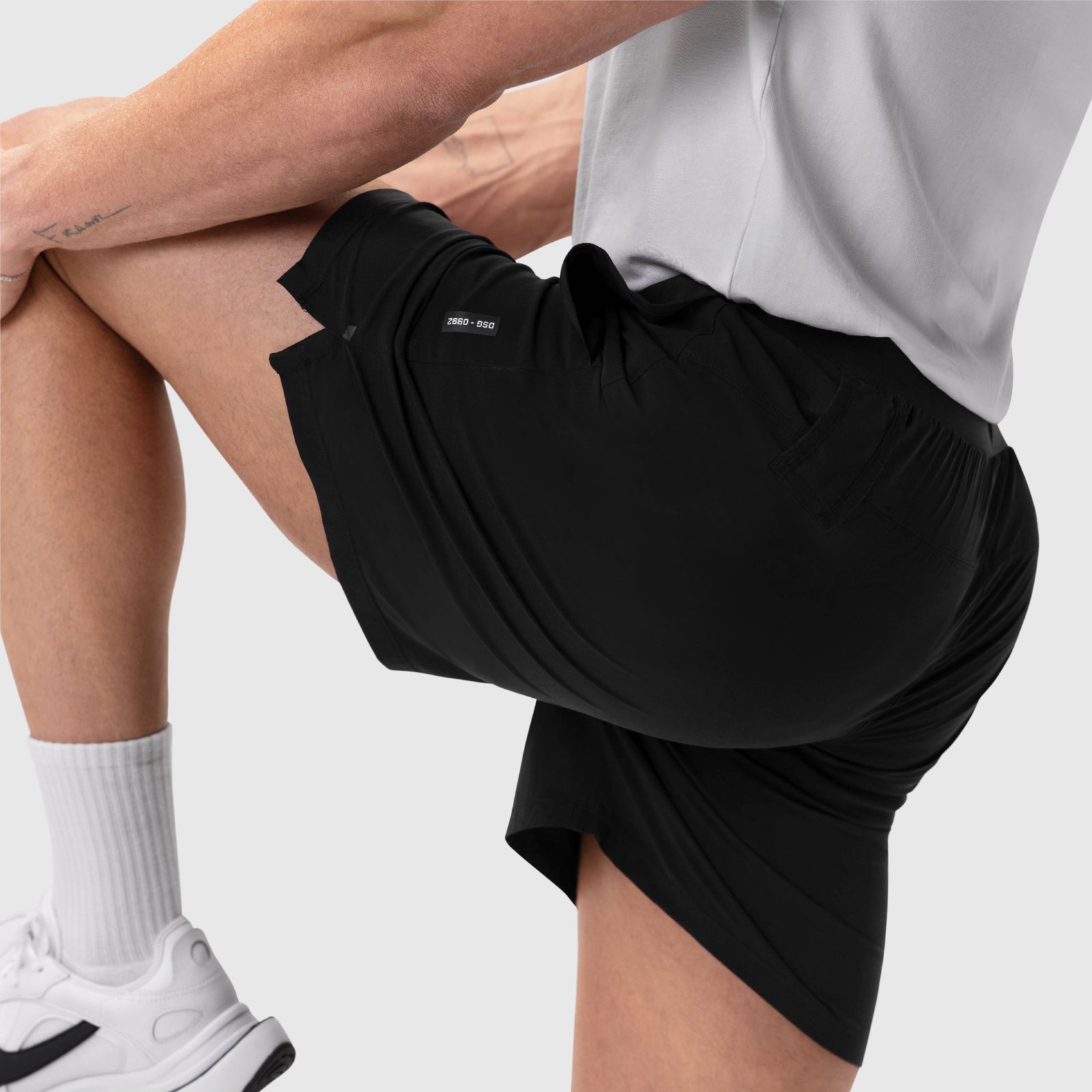 Aerotex™ 6" Training Short in black, worn by model with white socks and sneakers