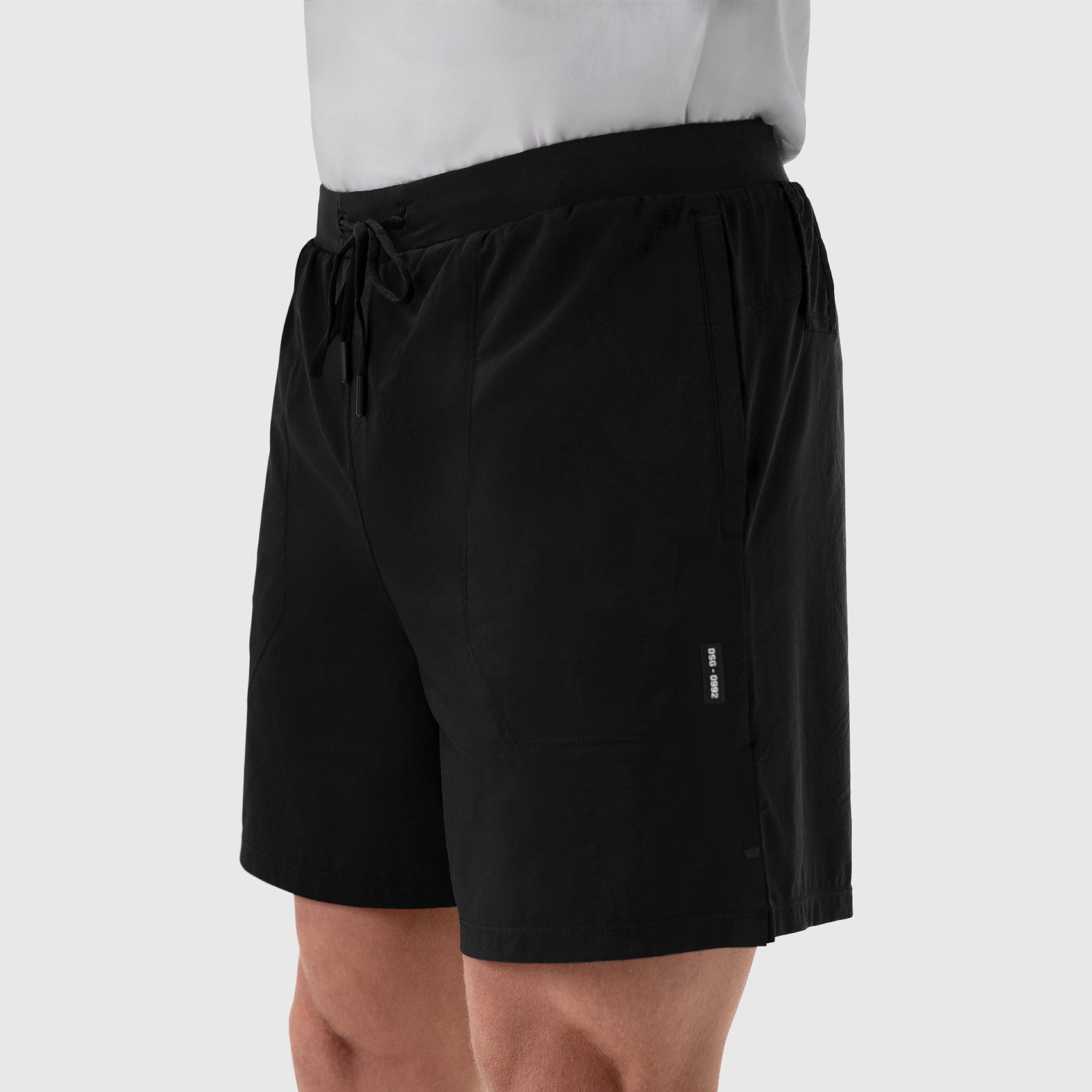 Aerotex™ 6" Training Short in black, worn by model with white shirt, side view
