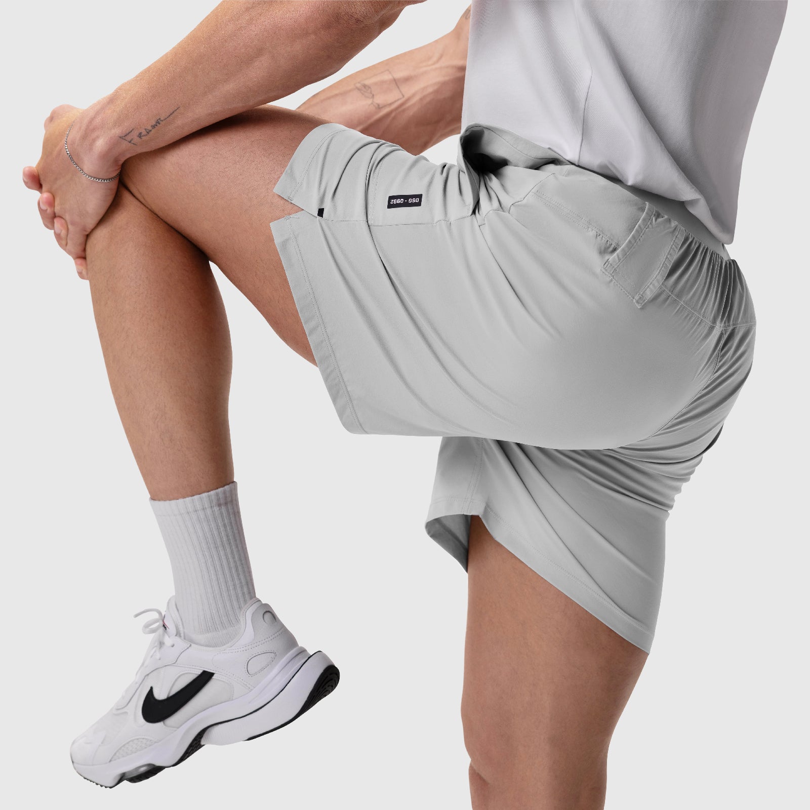 Aerotex Training Short in Slate Grey worn by model stretching leg, front view