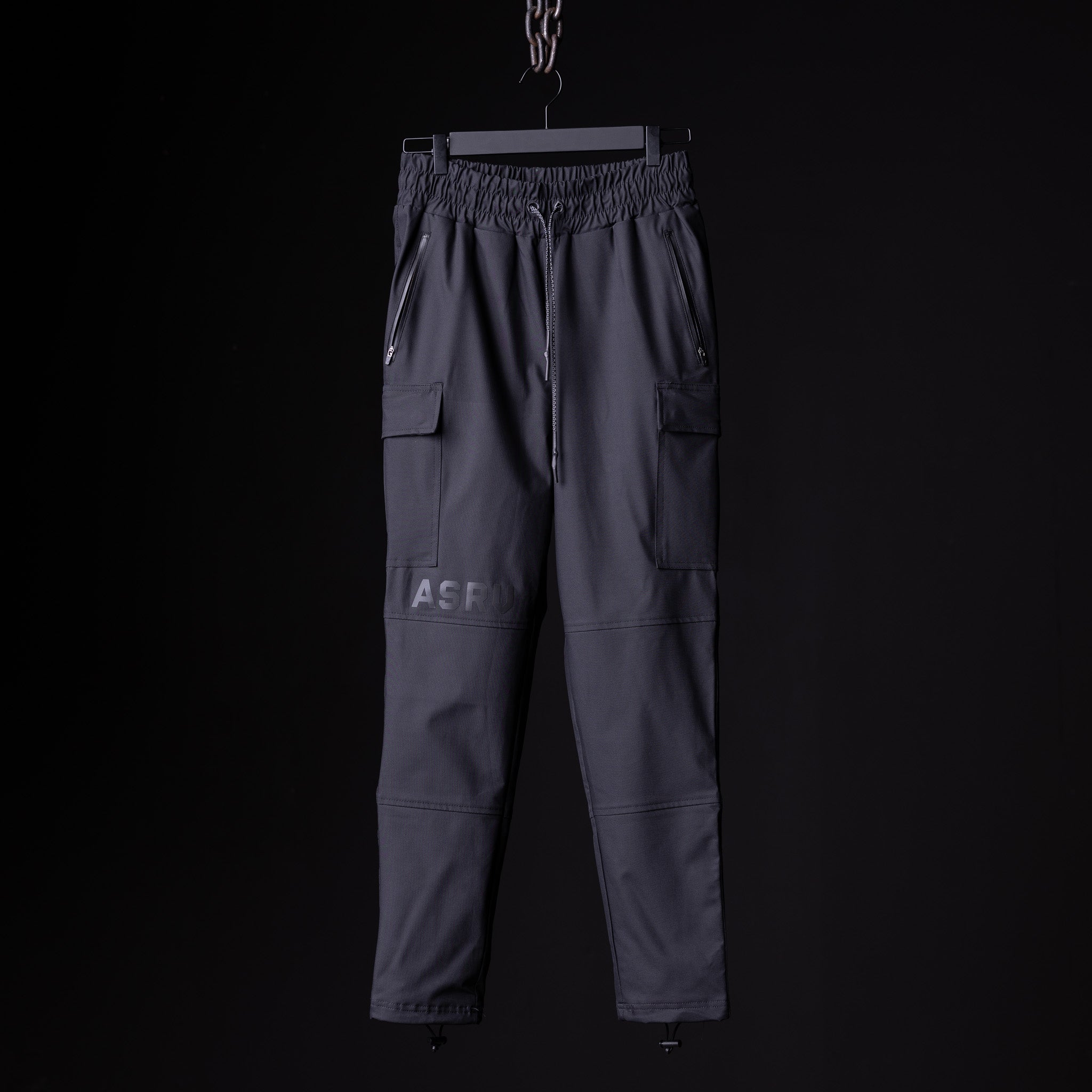 flatlay SP'20 Cargo Track Pant in charcoal grey with cargo pockets, front view