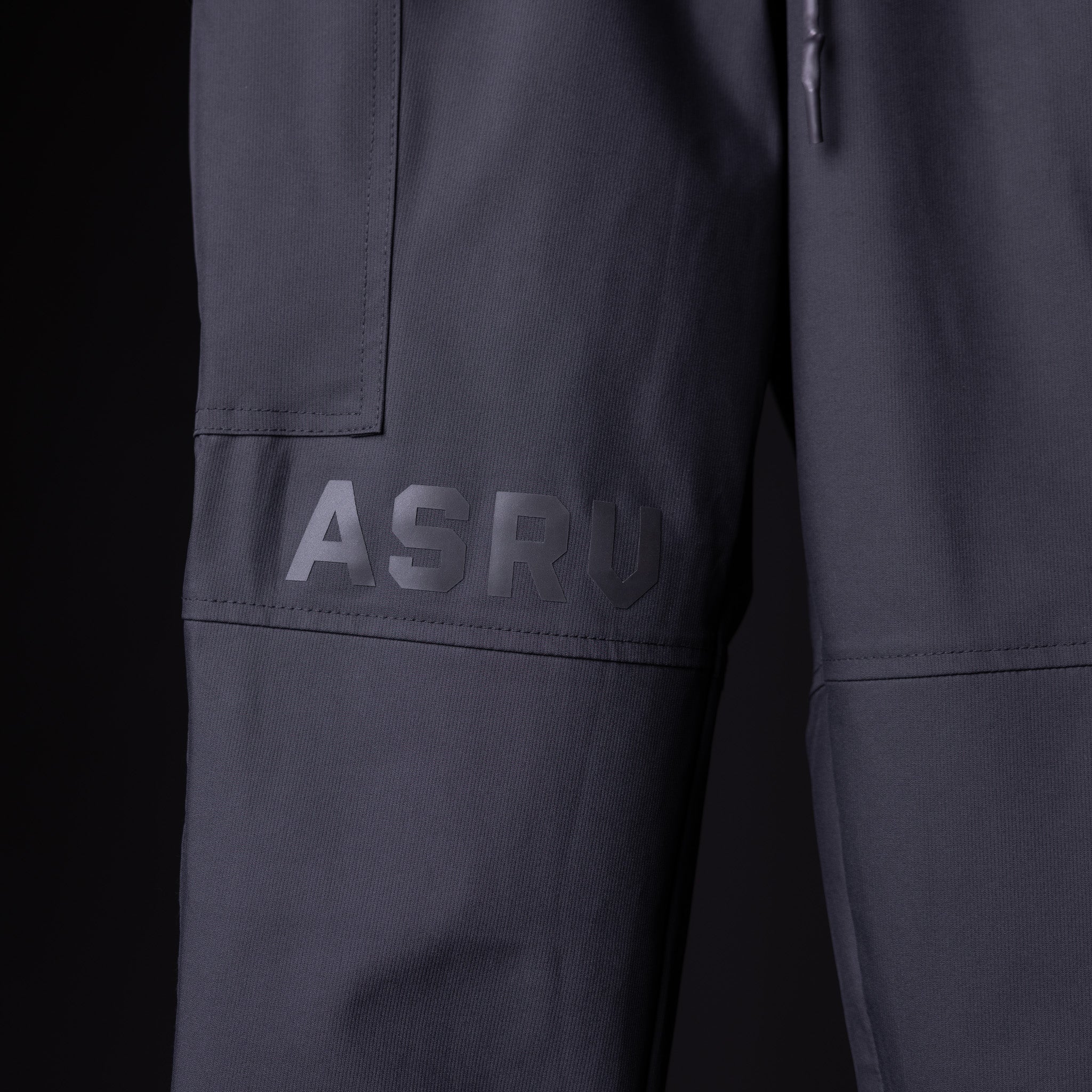 SP'20 Cargo Track Pant in charcoal gray, detail shot of leg pocket and ASRV branding