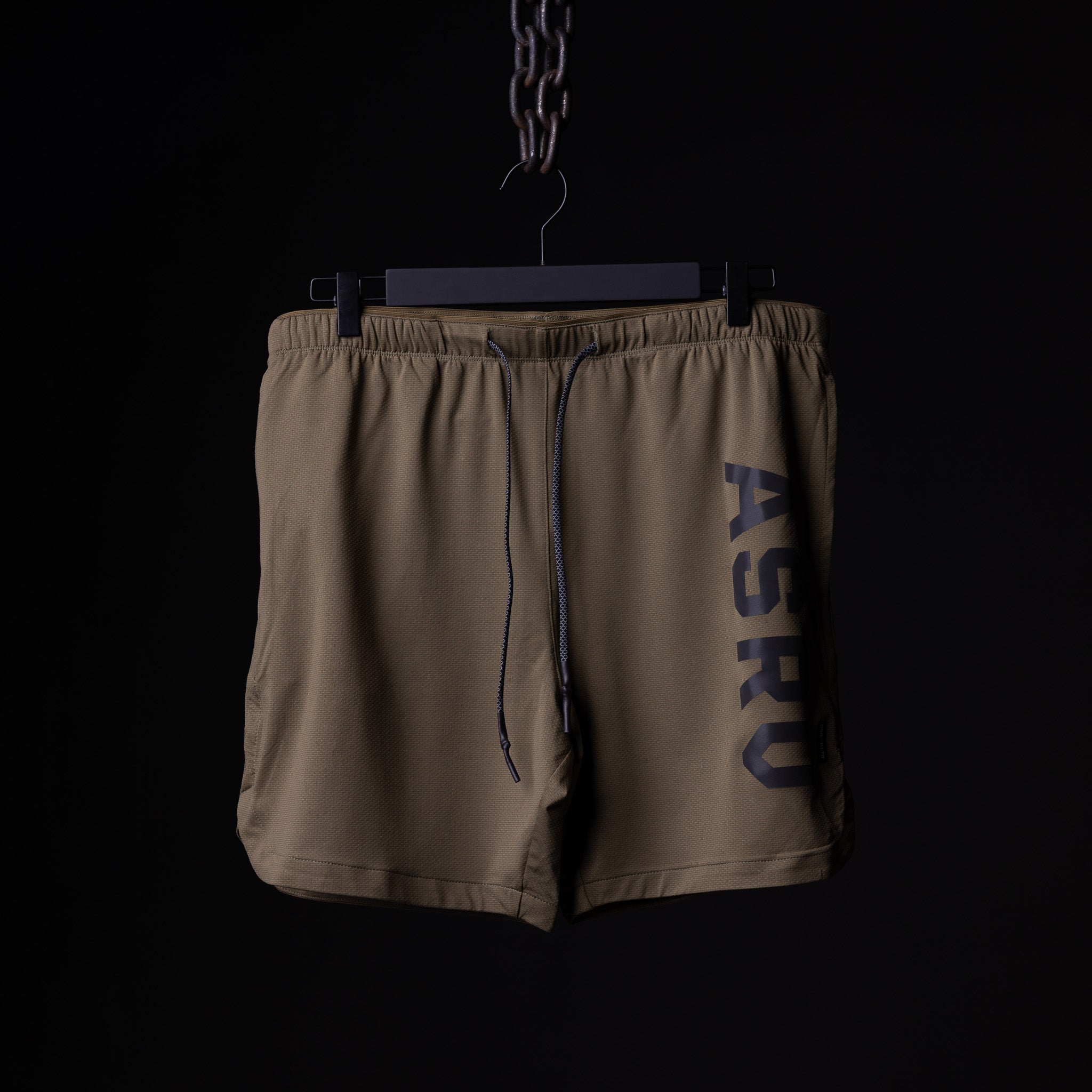 flatlay SP'19 7" Linerless Short in khaki tan, front view hanging on hanger
