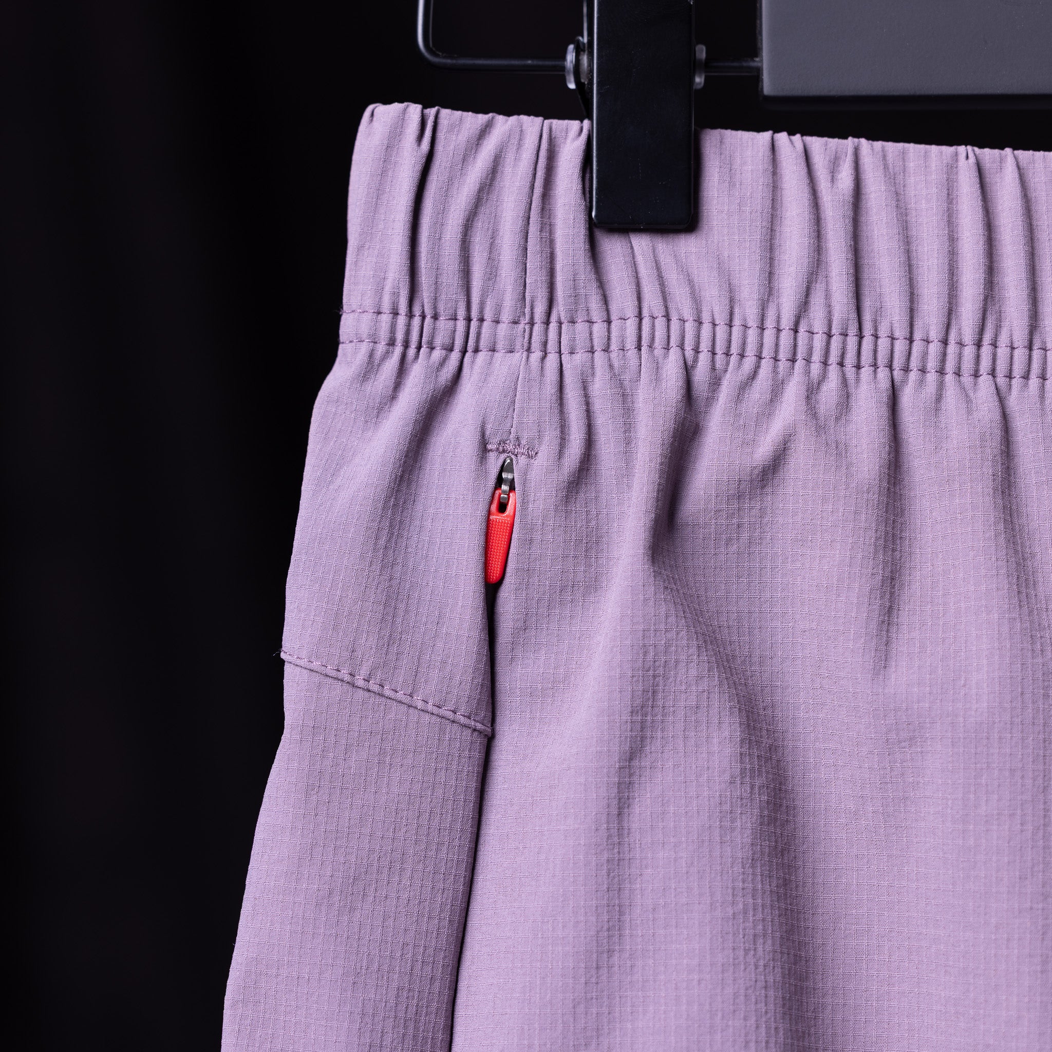 WN'23 6" Perforated Short in lavender, detail shot of pocket and zipper
