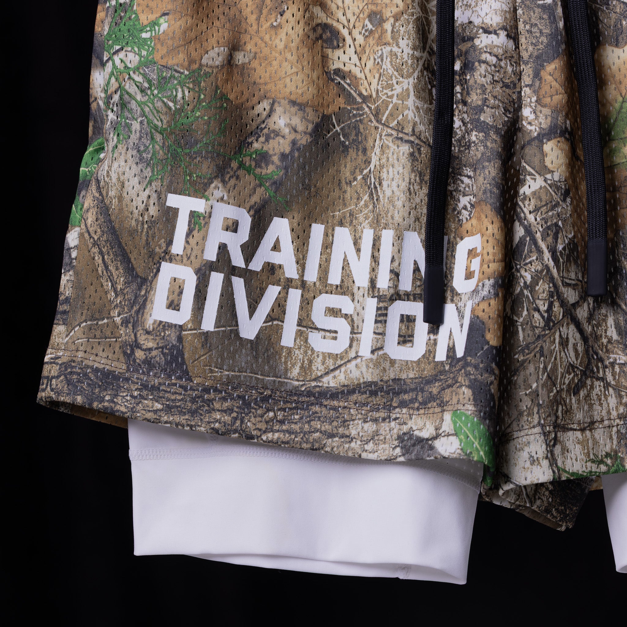 flatlay Training Division Mesh Shorts in camo with white underlay, front view
