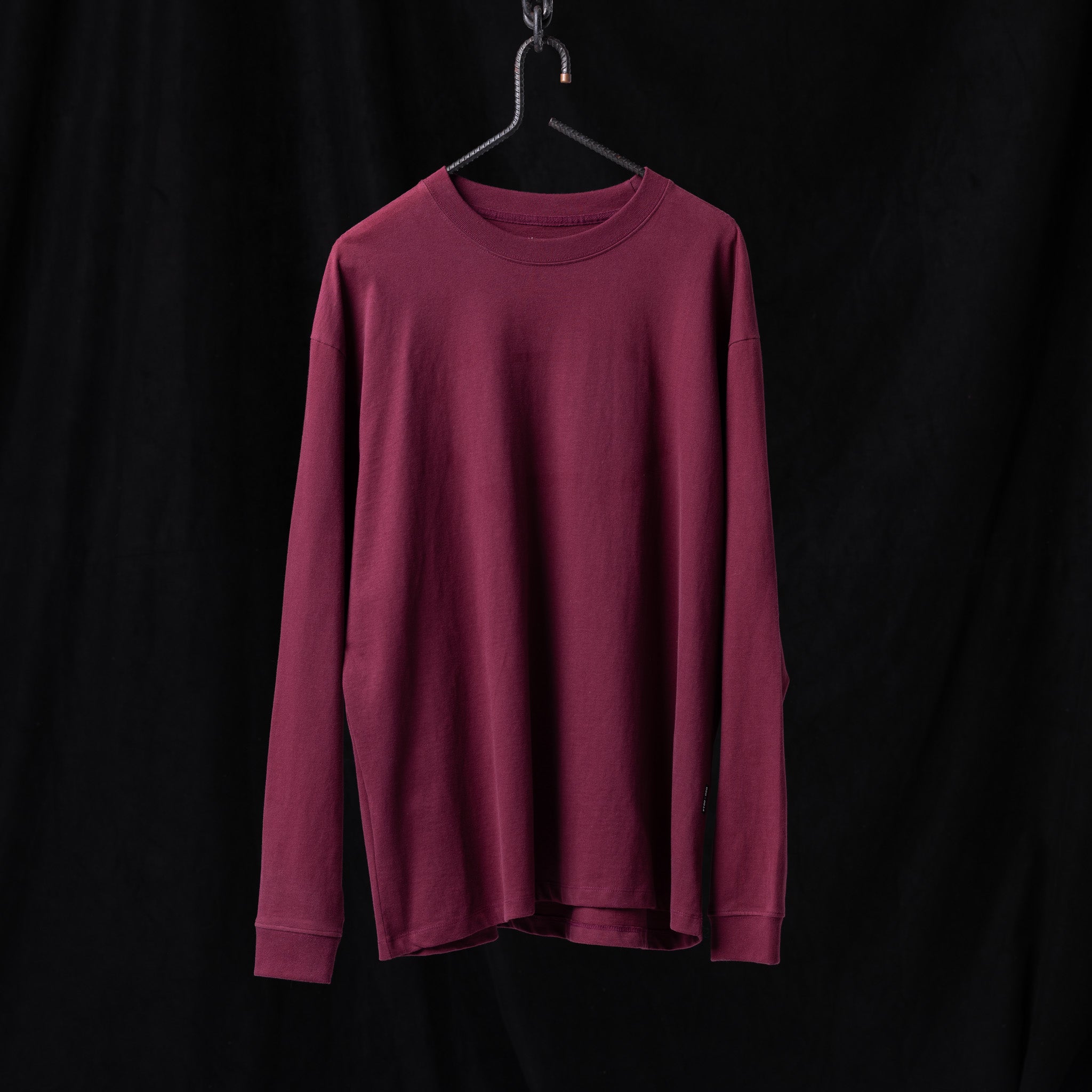 SM'22 Graphic Long Sleeve in burgundy on hanger against black background