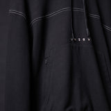 FA'20 Contrast Thread Hoodie in black with white stitching detail, draped fabric closeup