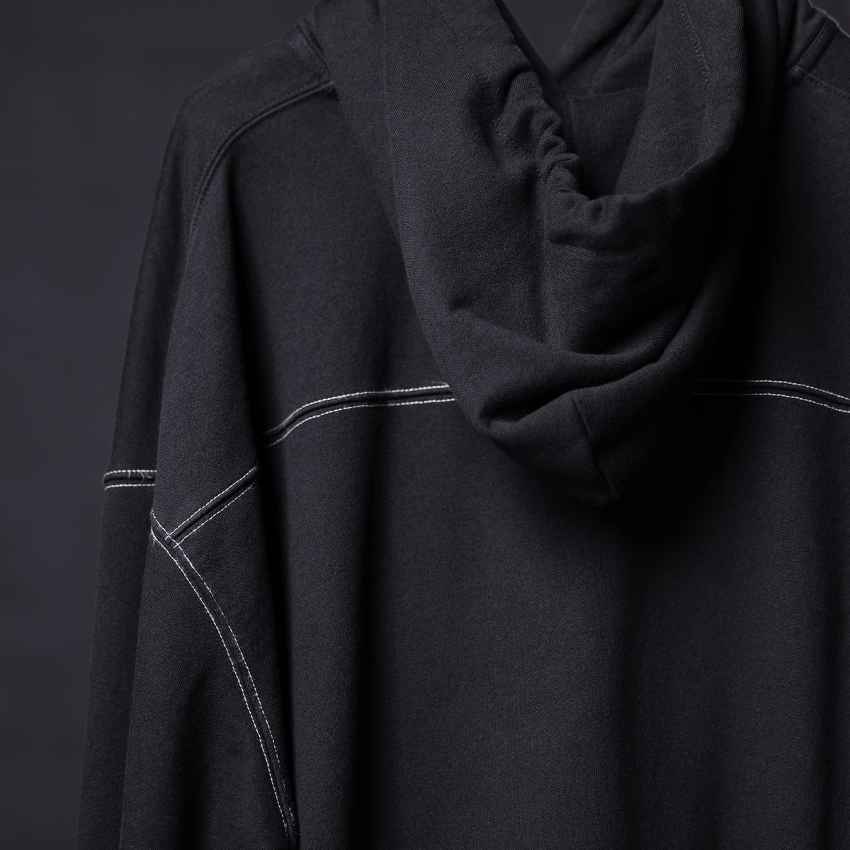FA'20 Contrast Thread Hoodie in black with white contrast stitching, worn on model