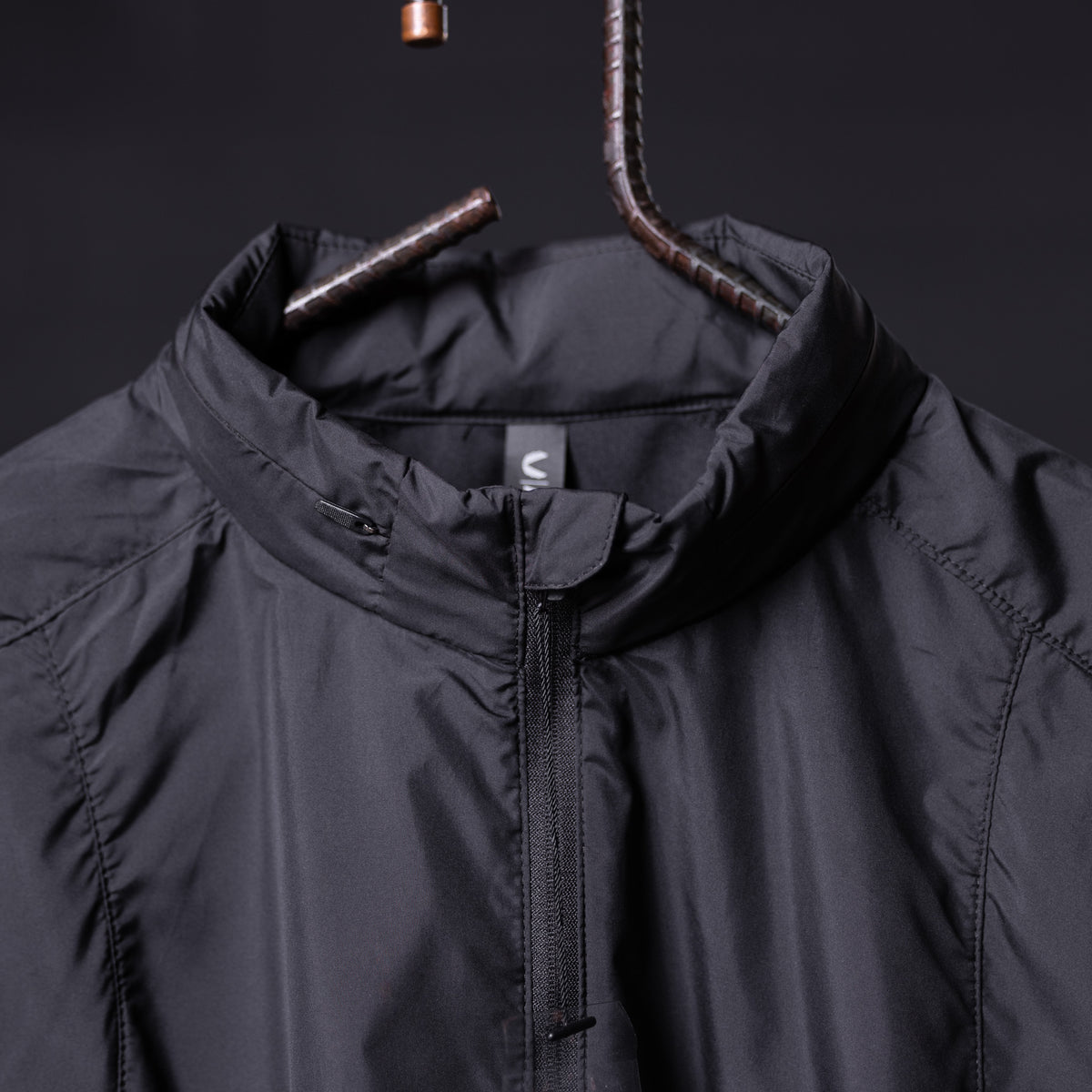 SP'22 Lightweight Windbreaker in black, front view on hanger
