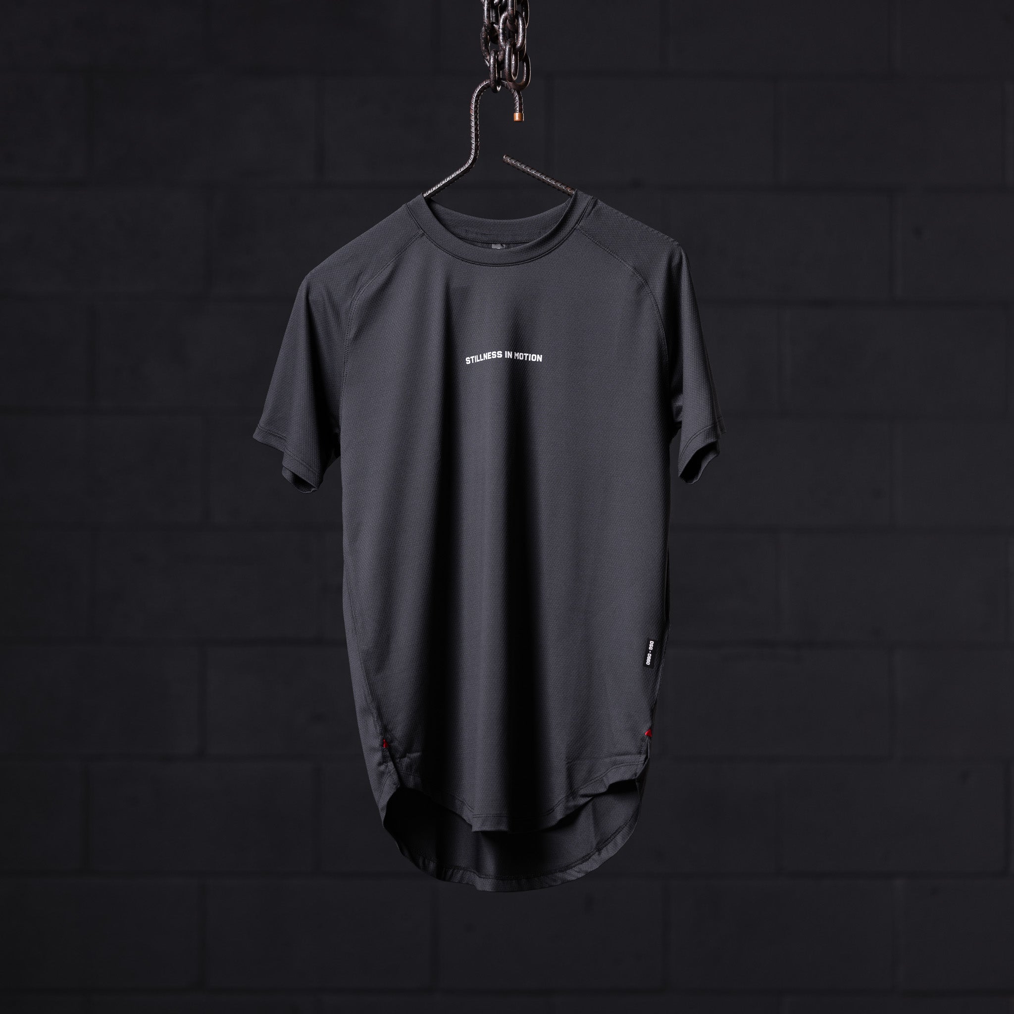 SM'22 Established Tee in charcoal gray, displayed on hanger against dark background