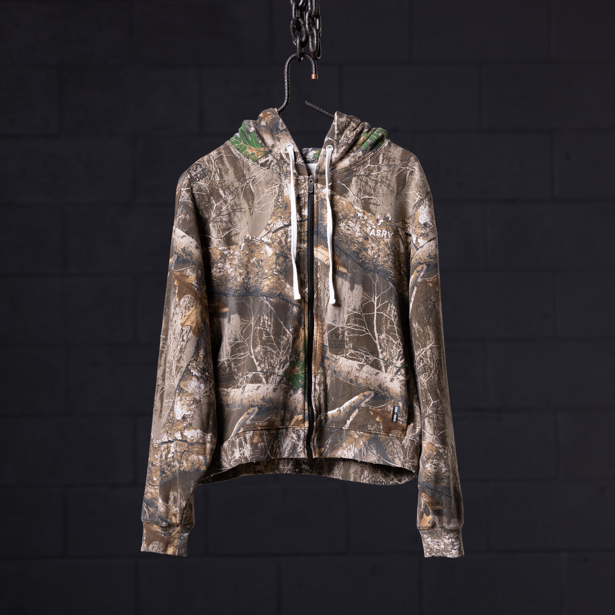 Distressed Warmup Zip Hoodie in brown camo, displayed on hanger against dark background