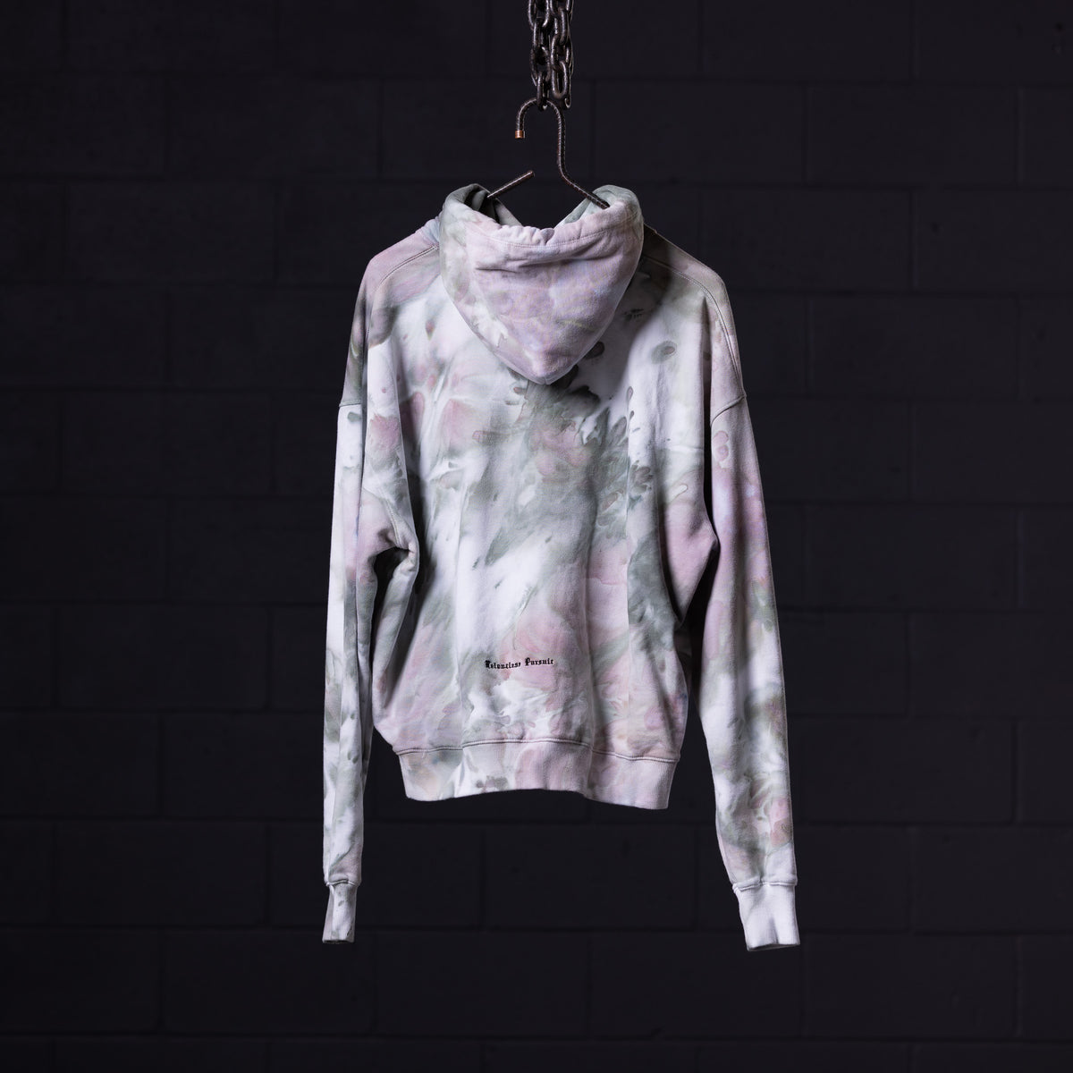 SM'22 Tie Dye Hoodie in pink and grey tie dye, displayed on hanger from back view