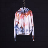 SM'22 Tie Dye Hoodie in white with red and blue tie dye pattern, hanging on chain against dark background