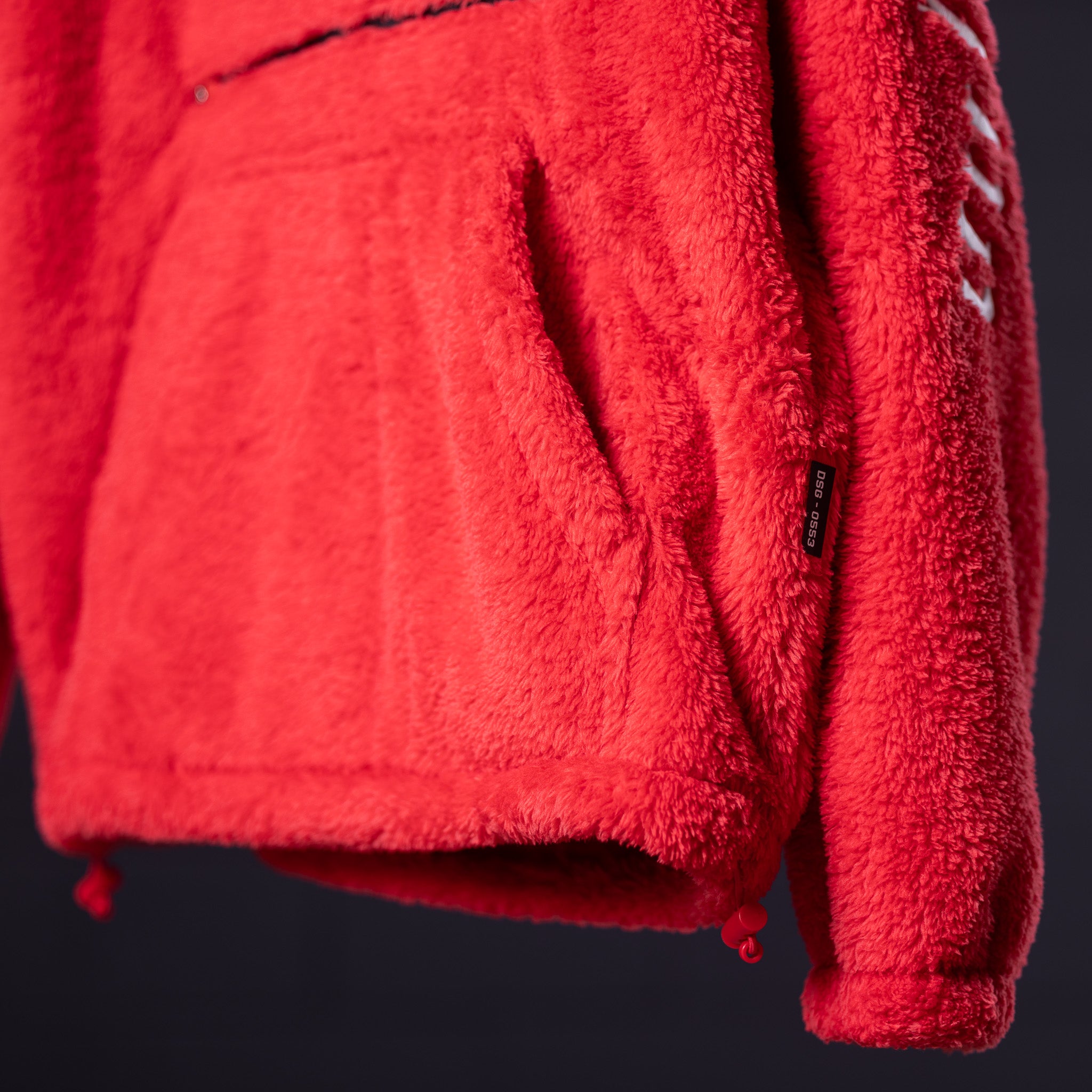 WN '23 Sherpa Recovery Hoodie in red, detail shot of fabric texture and pocket