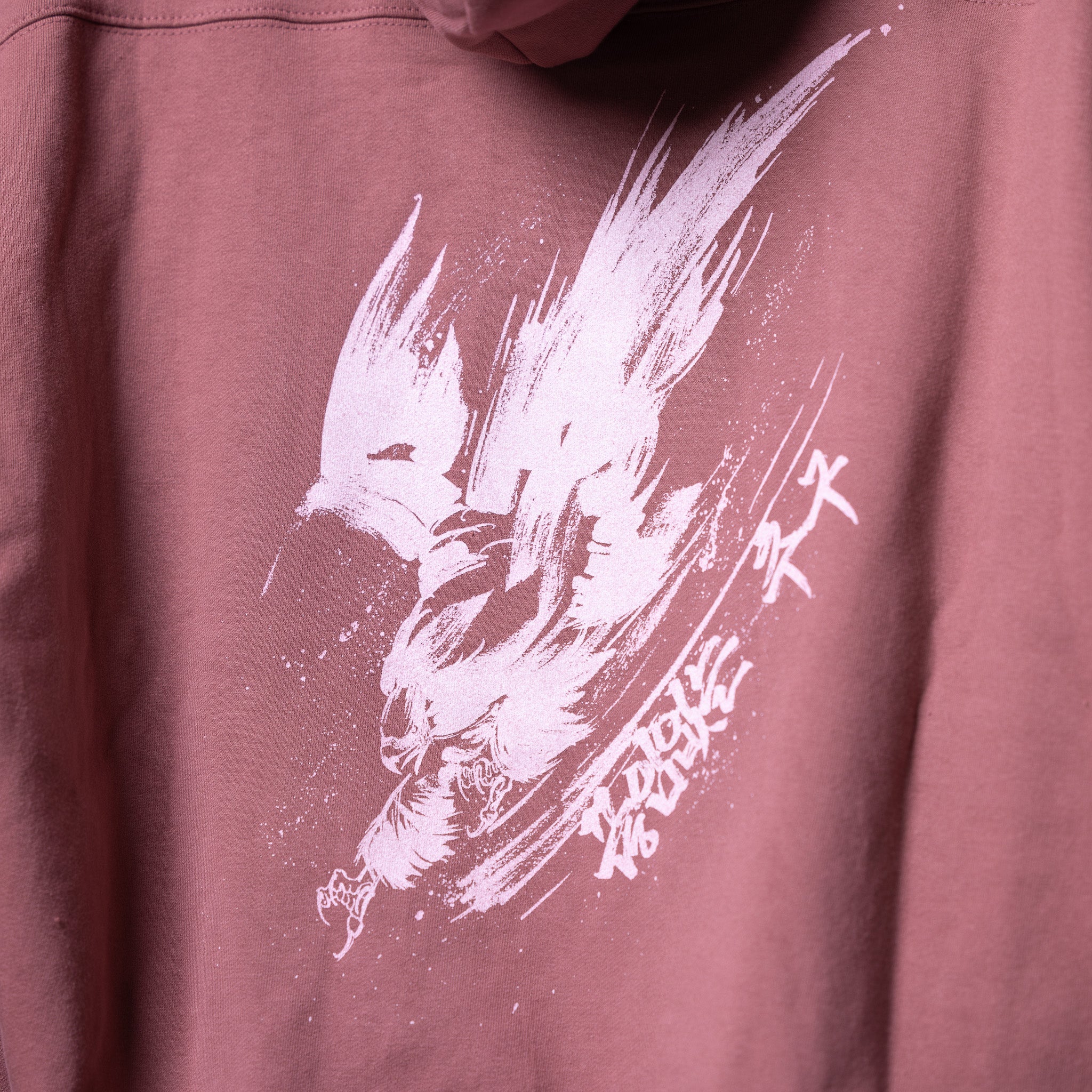 FA'22 Tech Terry Eagle Hoodie in mauve worn by model, front graphic detail view