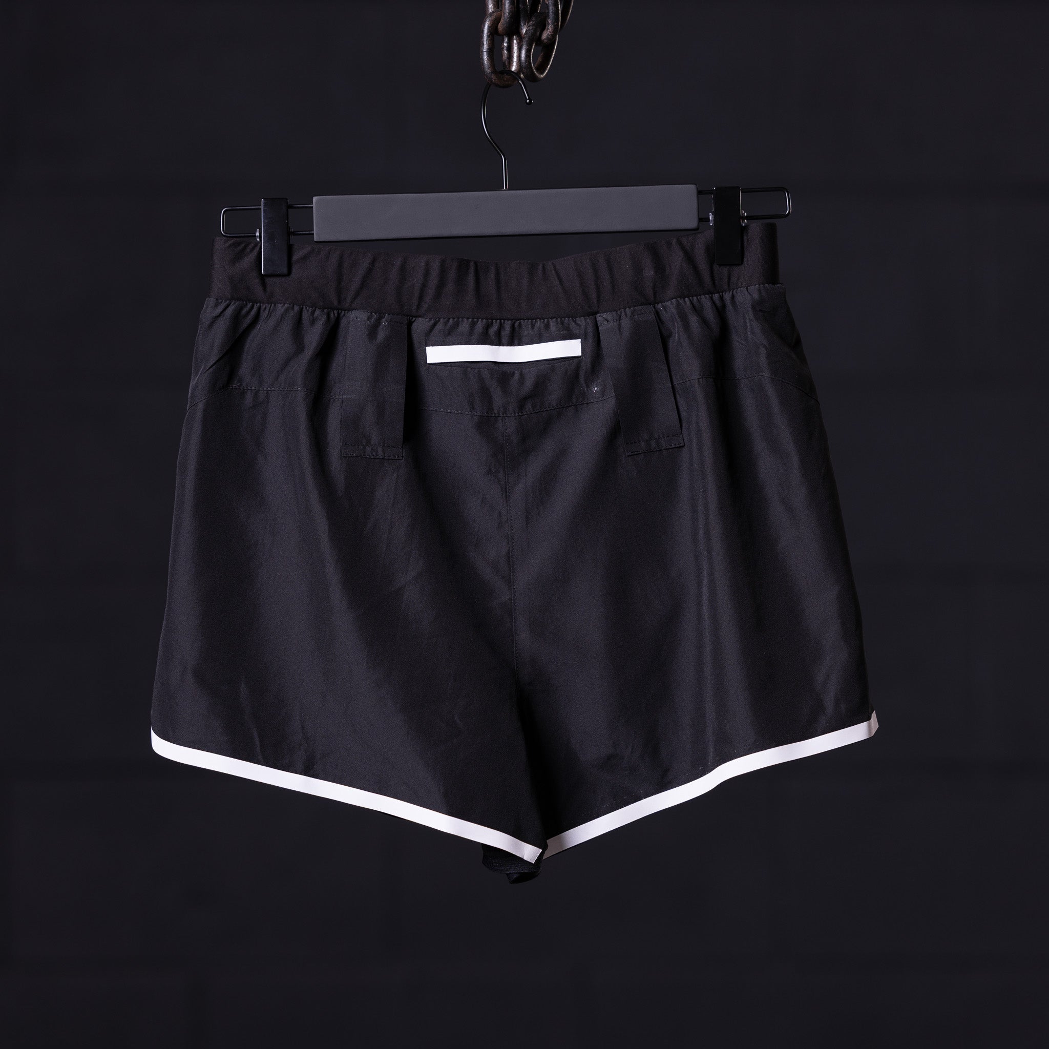 Reflective 3" Run Short in black with white trim, front view on hanger