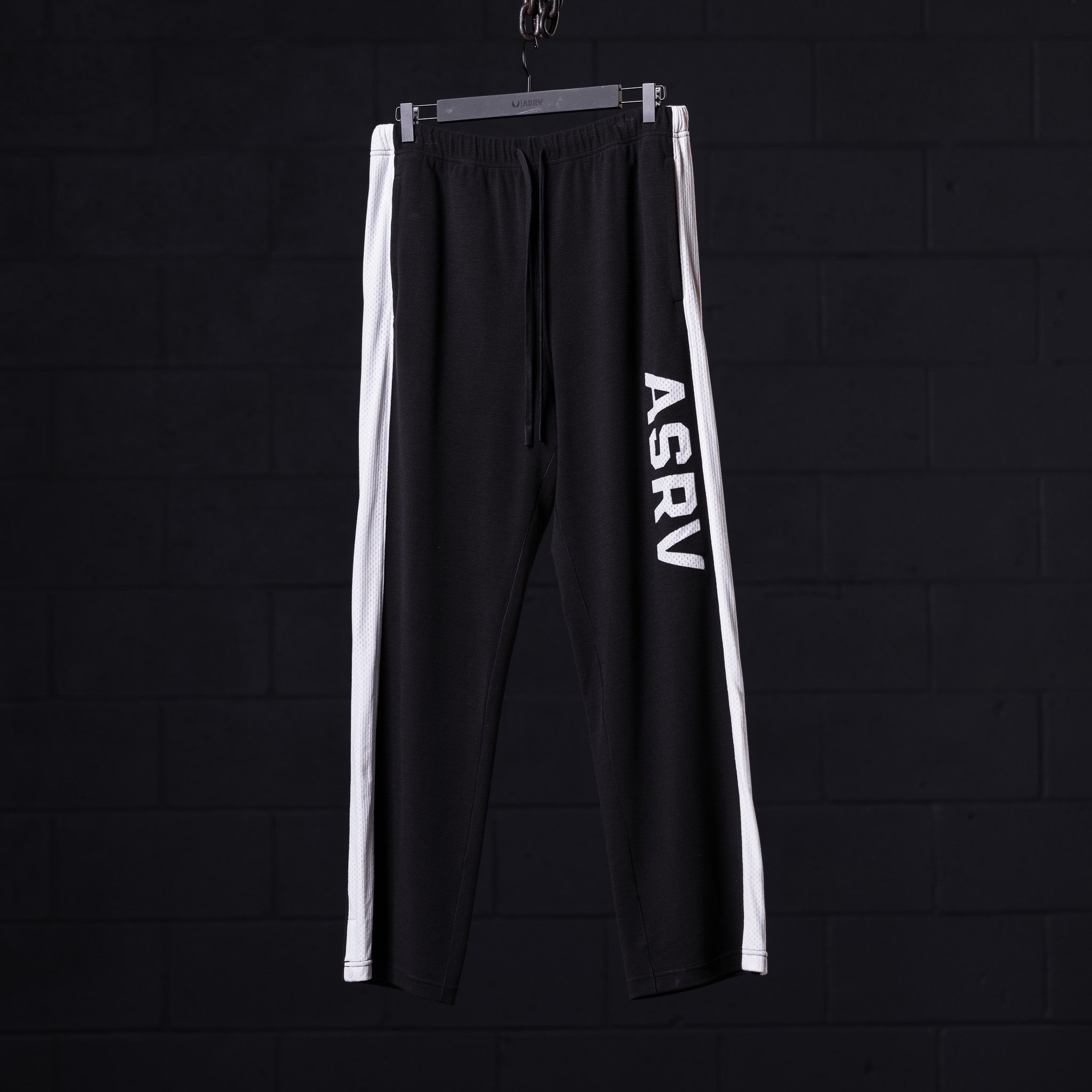 flatlay of ASRV SM'24 Waffle Knit Sweat Pant in black with white stripe, front view