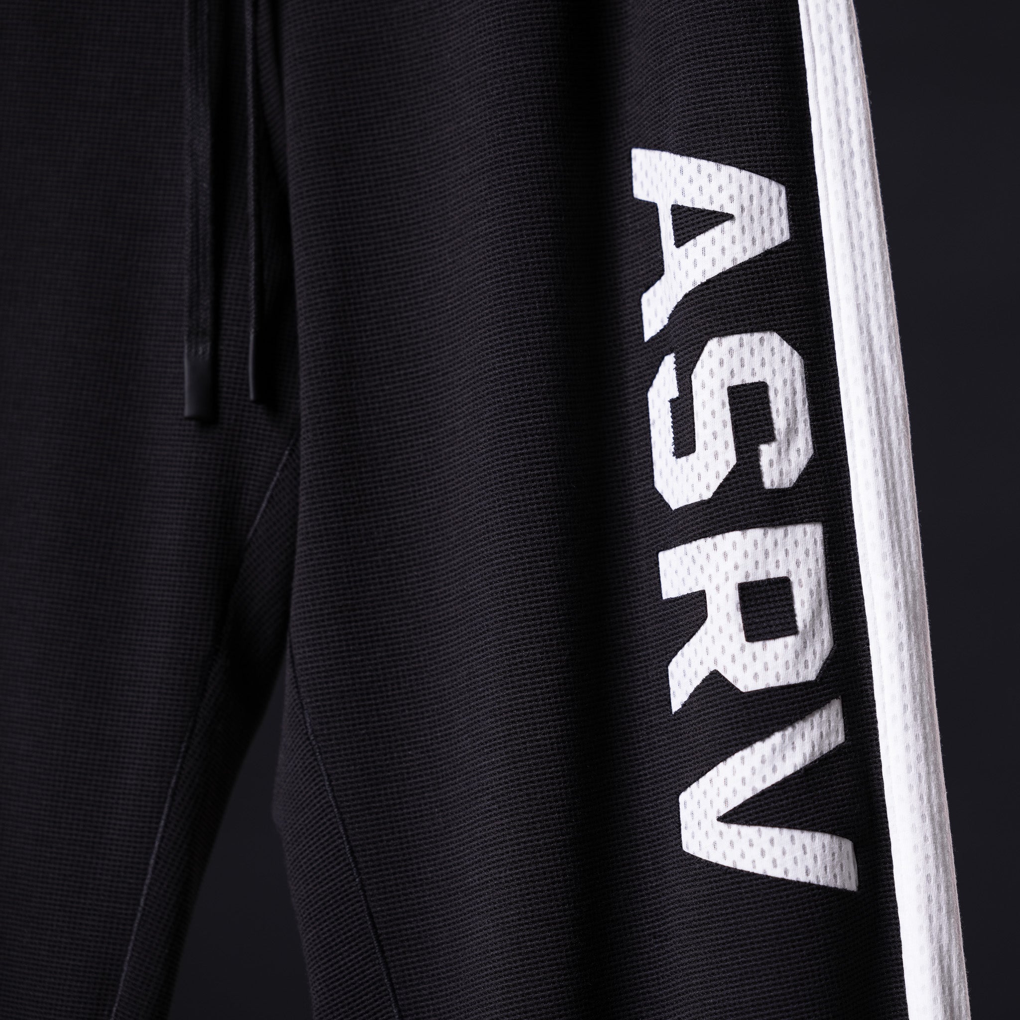 SM'24 Waffle Knit Sweat Pant in black, side detail of leg with white ASRV branding