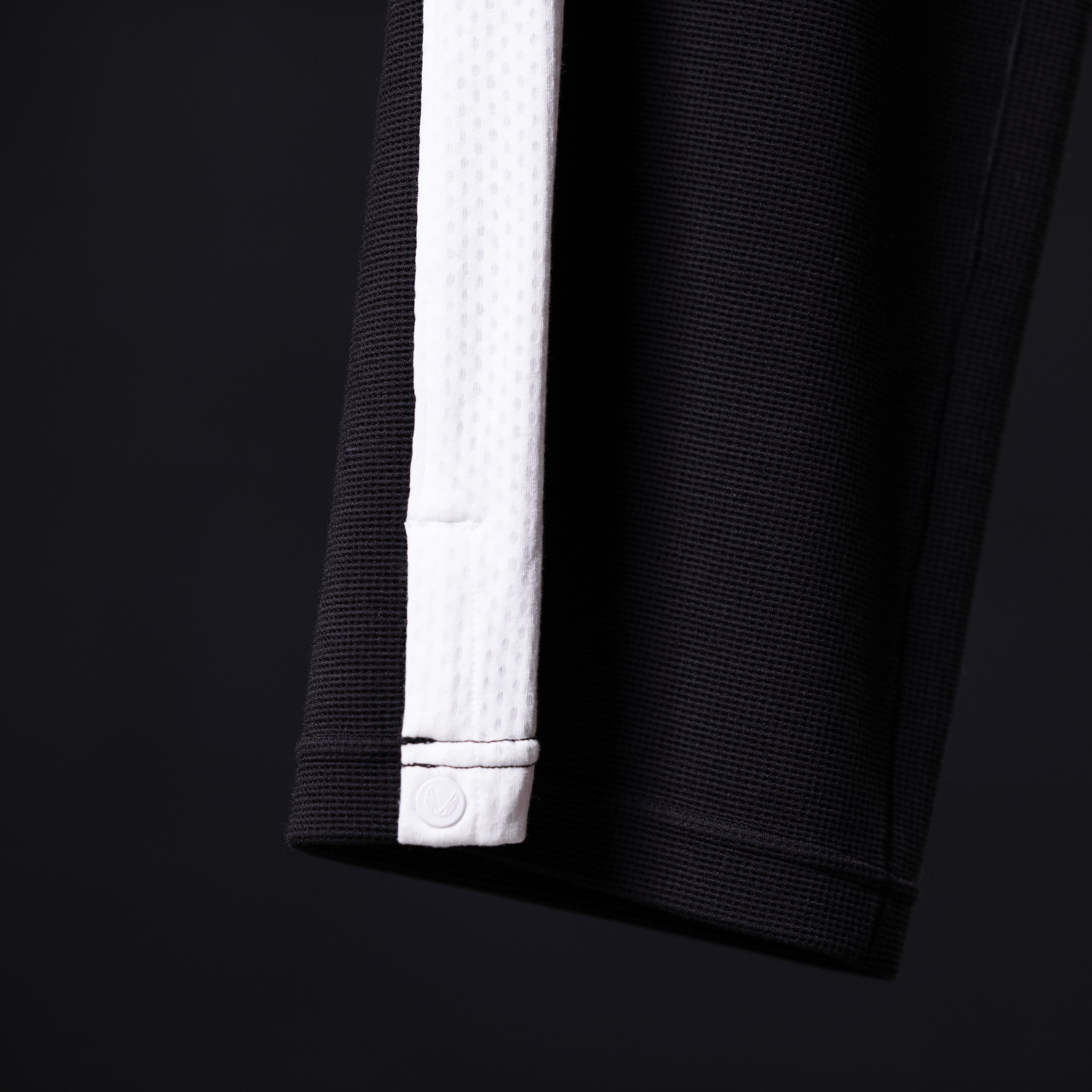 Flatlay of SM'24 Waffle Knit Sweat Pant in black with white cuff detail, laid flat on dark background