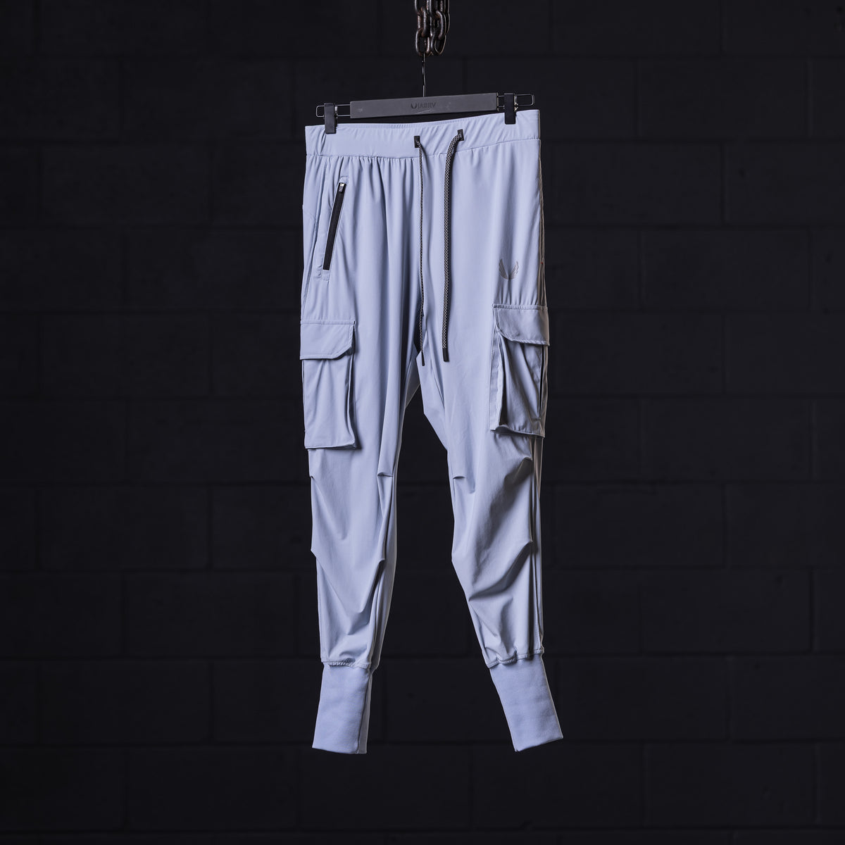WN'22 Cargo High Rib Jogger in light gray with cargo pockets, front view, on hanger