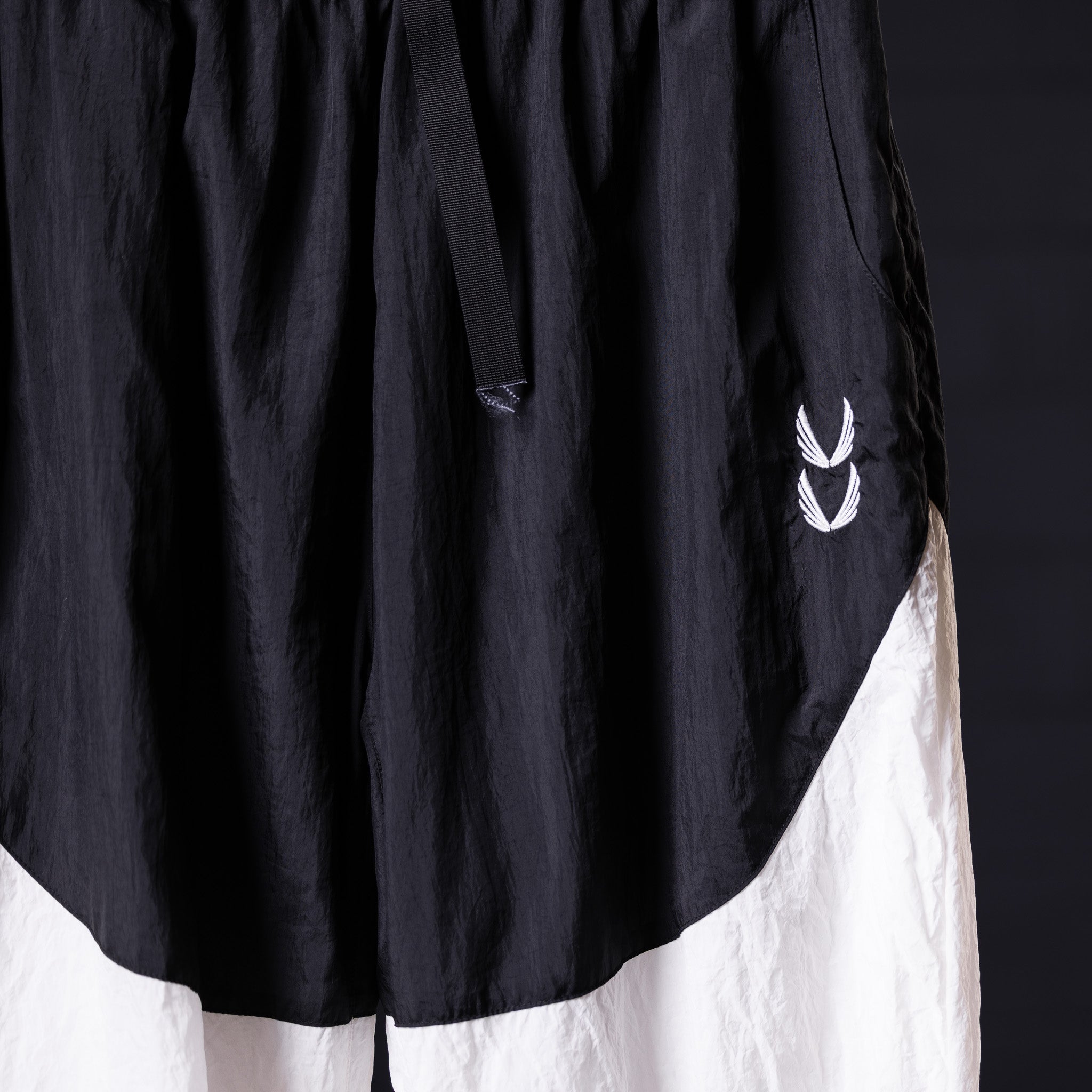 Oversized track pant in black and white, worn on model, showing side detail and branding