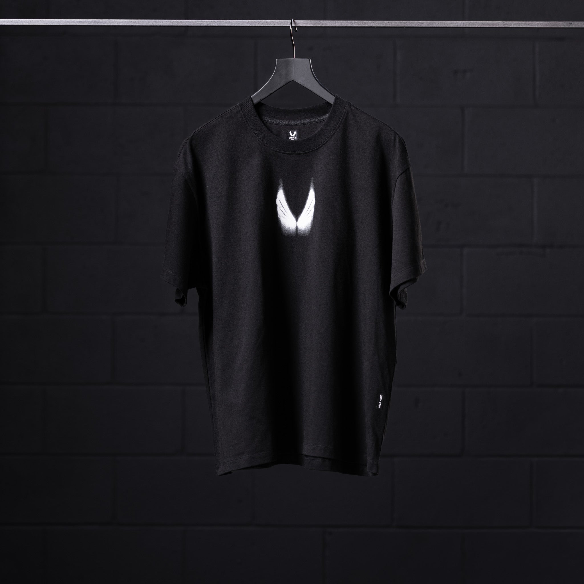 Black Tech Essential Relaxed Tee with white Motion Blur graphic, displayed on hanger