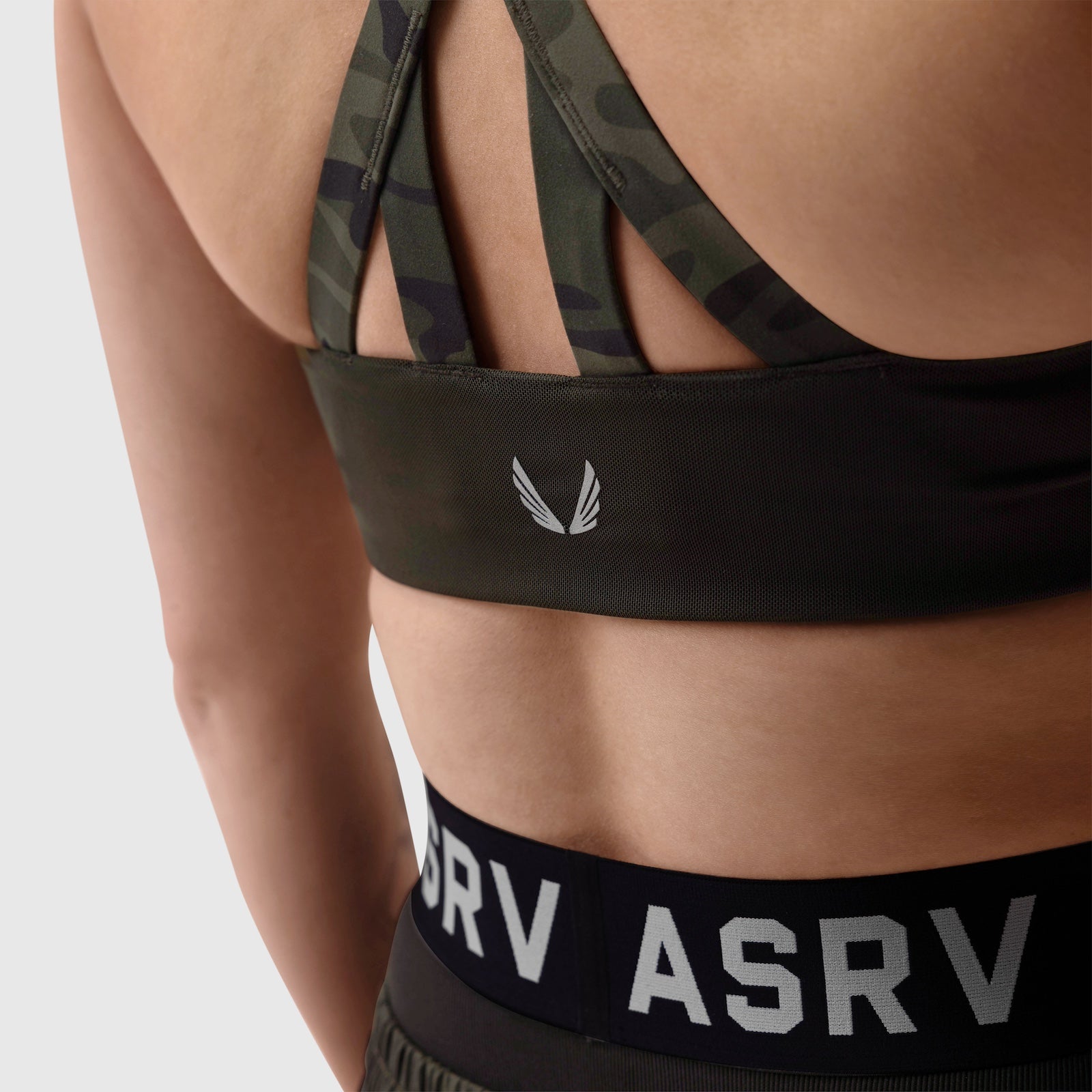LYCRA® Hybrid Sports Bra in Dark Camo worn by model, front detail view