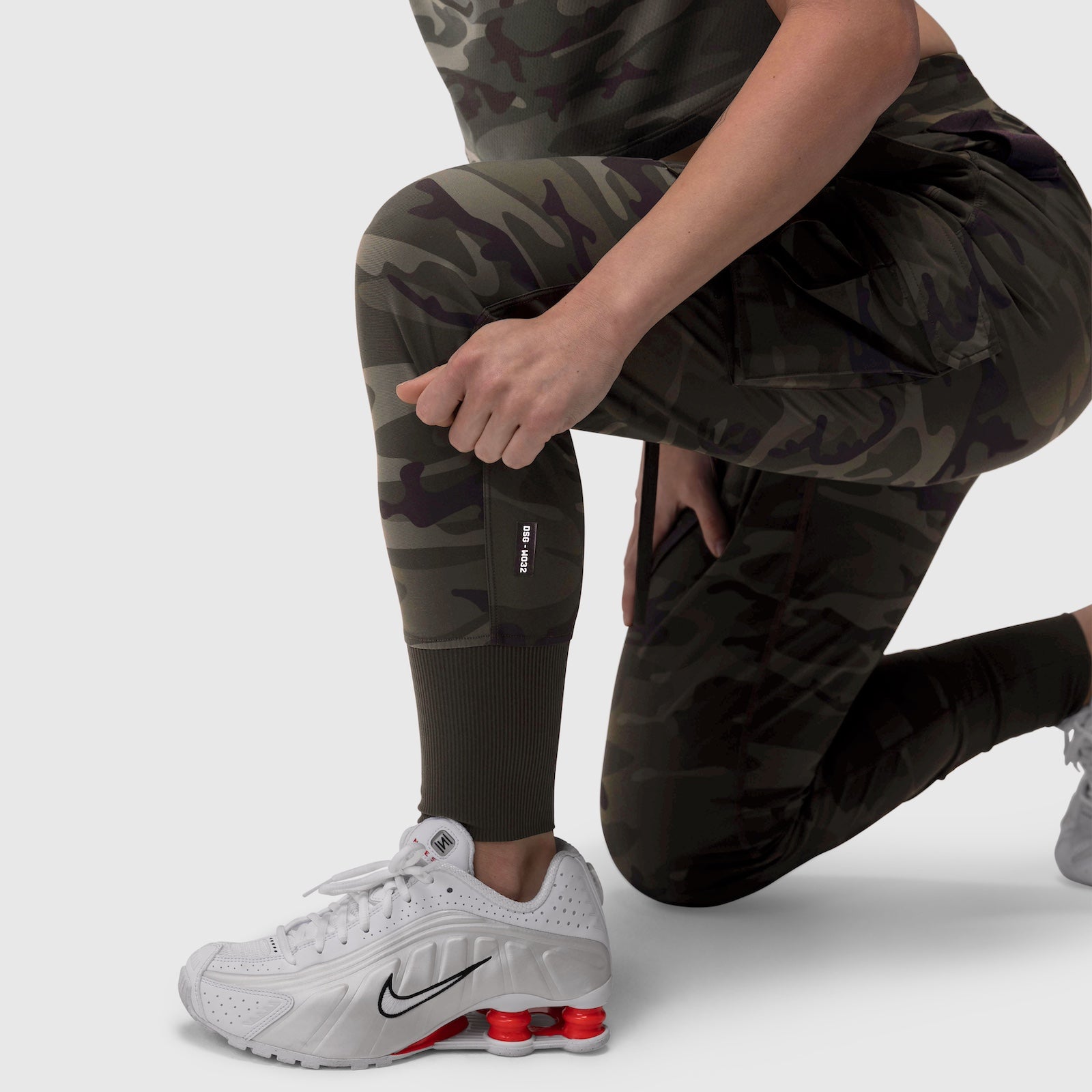 W032 Tetra-Lite Cargo High Rib Jogger in dark camo, worn with white sneakers, lifestyle pose