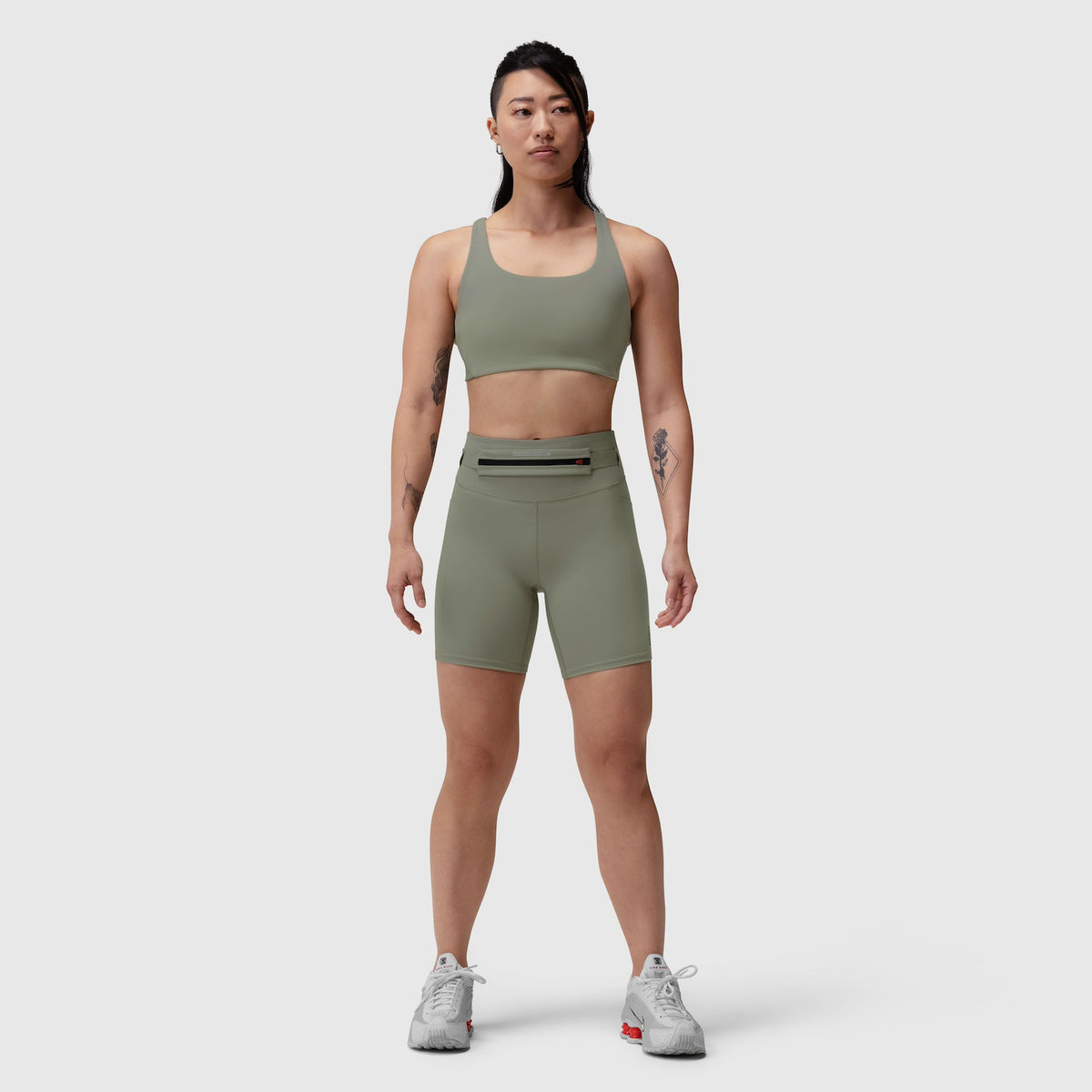 W039 Lycra Hybrid Sports Bra in sage, worn by model with matching shorts, front view