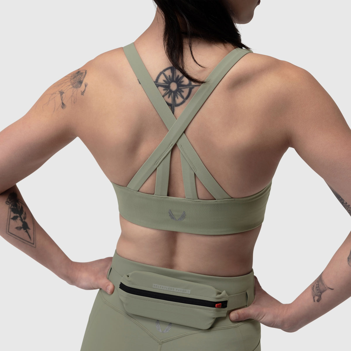 Sage Lycra hybrid sports bra on model, back view showing criss-cross strap design