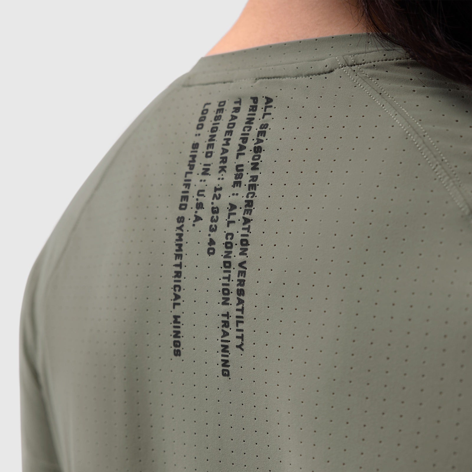 Laser-Vent Established Tee in sage worn by model, back view showing perforated fabric and text detail