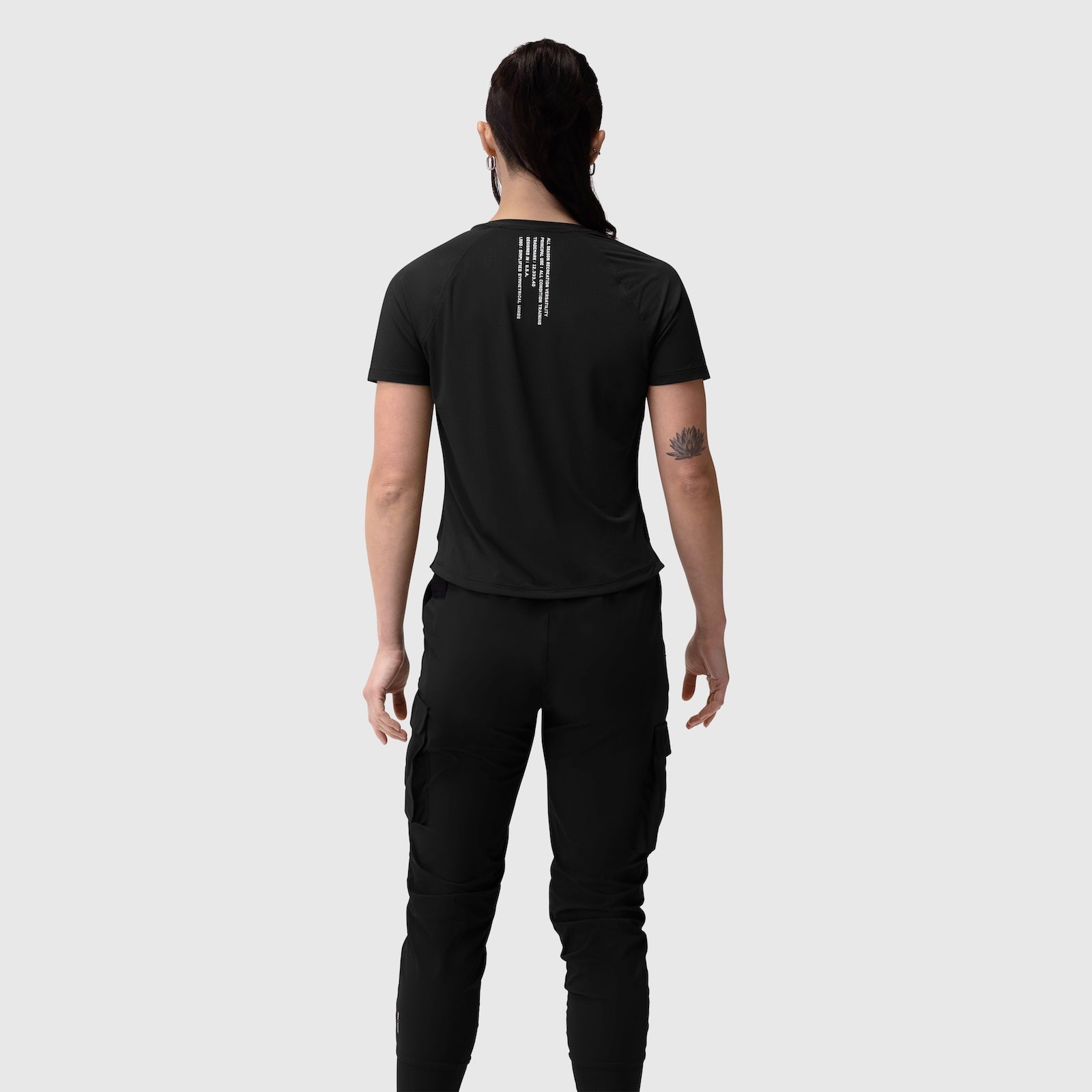 Black Laser-Vent Established Tee worn by model, back view showing rear graphic detail