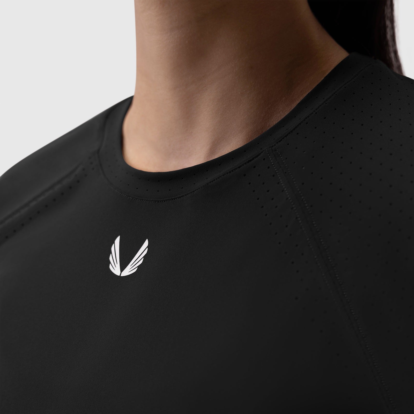 Black Laser-Vent Established Tee worn by model, chest logo detail view