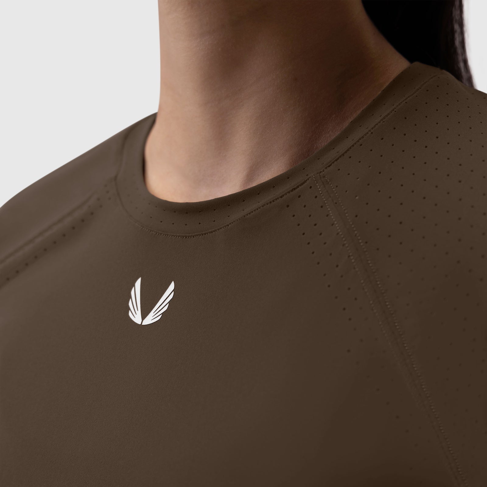 Laser-Vent Established Tee in Dark Earth, worn by model showing chest logo detail