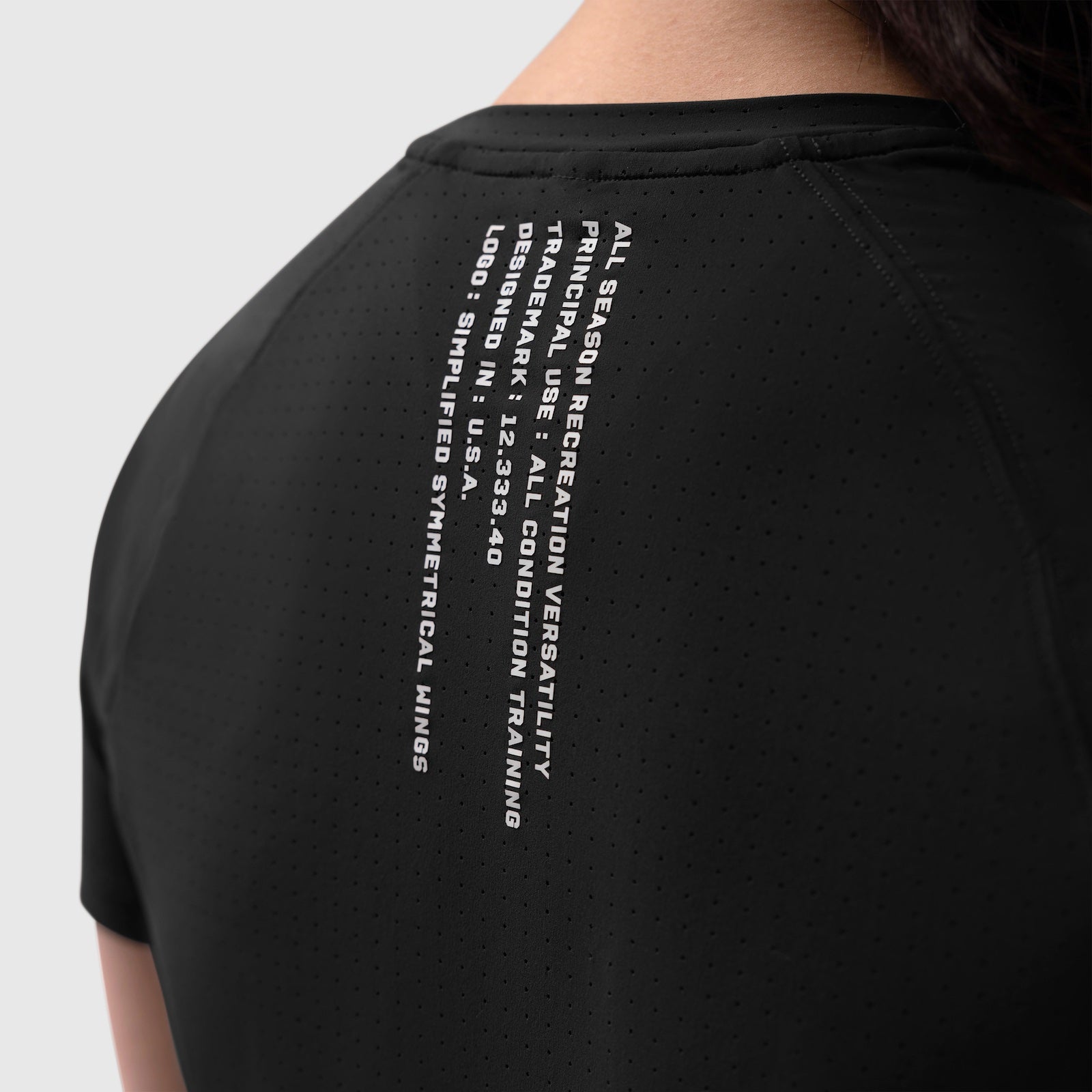 Black Laser-Vent Established Tee worn by model, back view showing text graphic