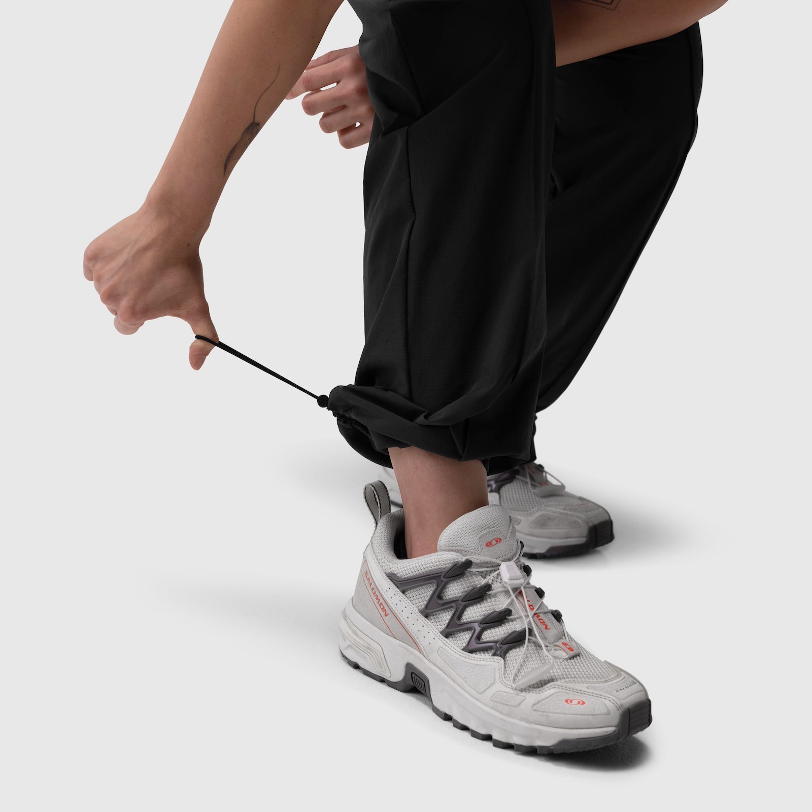 W036 Ripstop Relaxed Track Pant in black, worn with white sneakers, front view