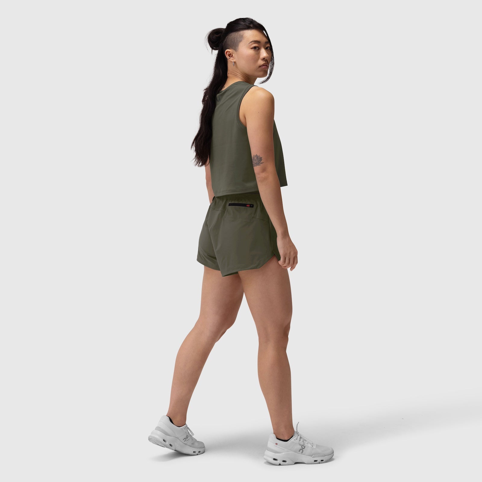 Tetra-Lite Linerless Short in olive, worn by model in side profile stance