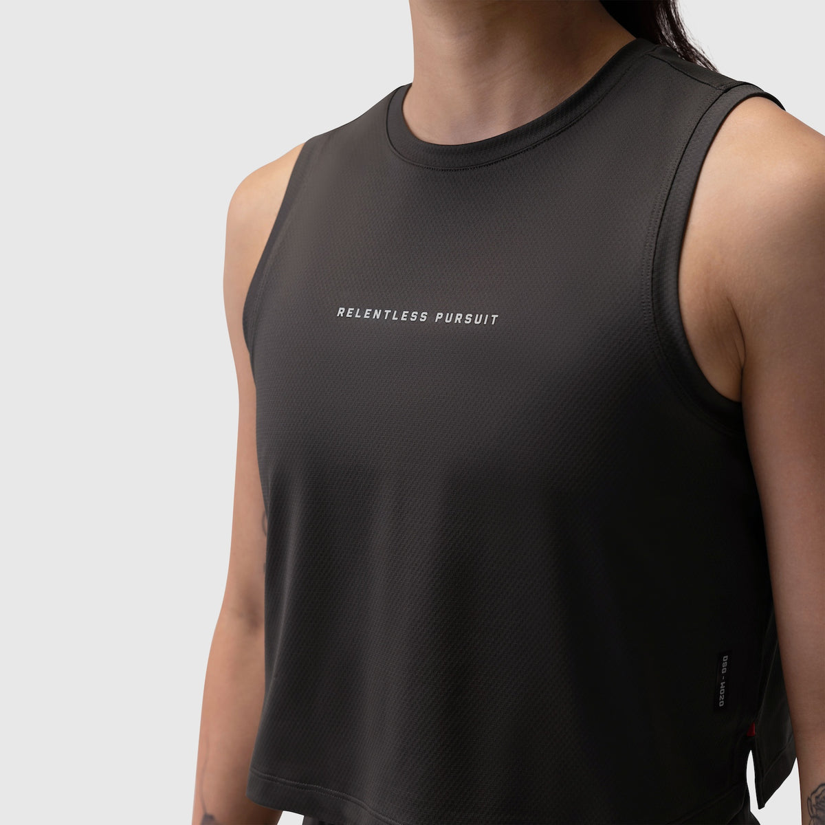 Black AeroSilver® tank top with 'Relentless Pursuit' text, worn by model, front view