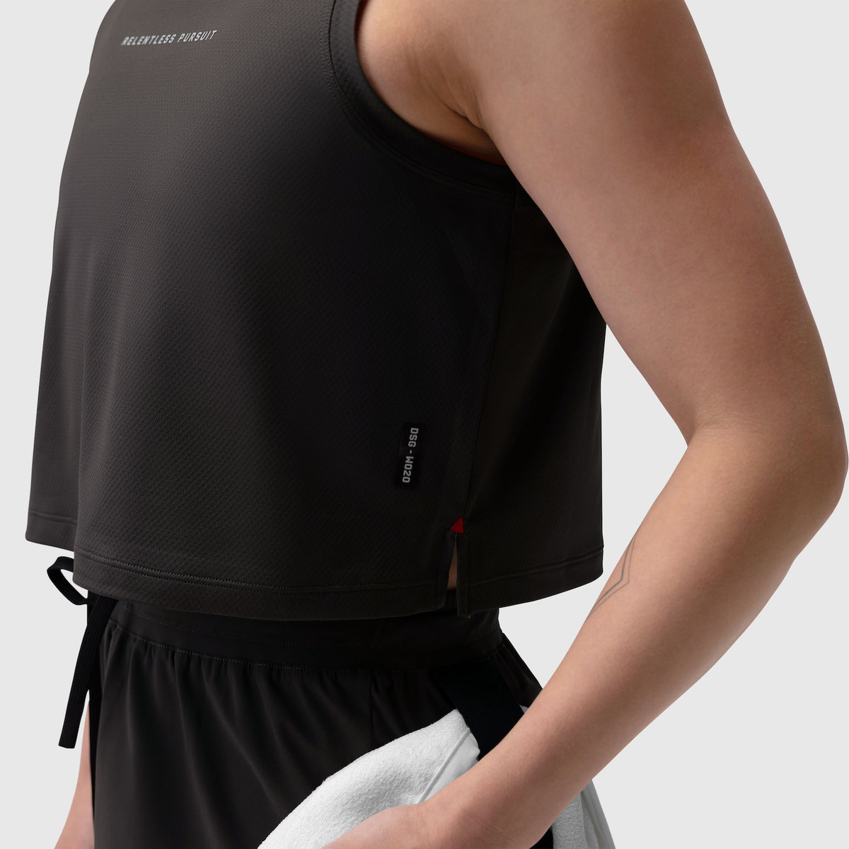 Black AeroSilver® tank top worn by model, side view showing fabric texture and fit