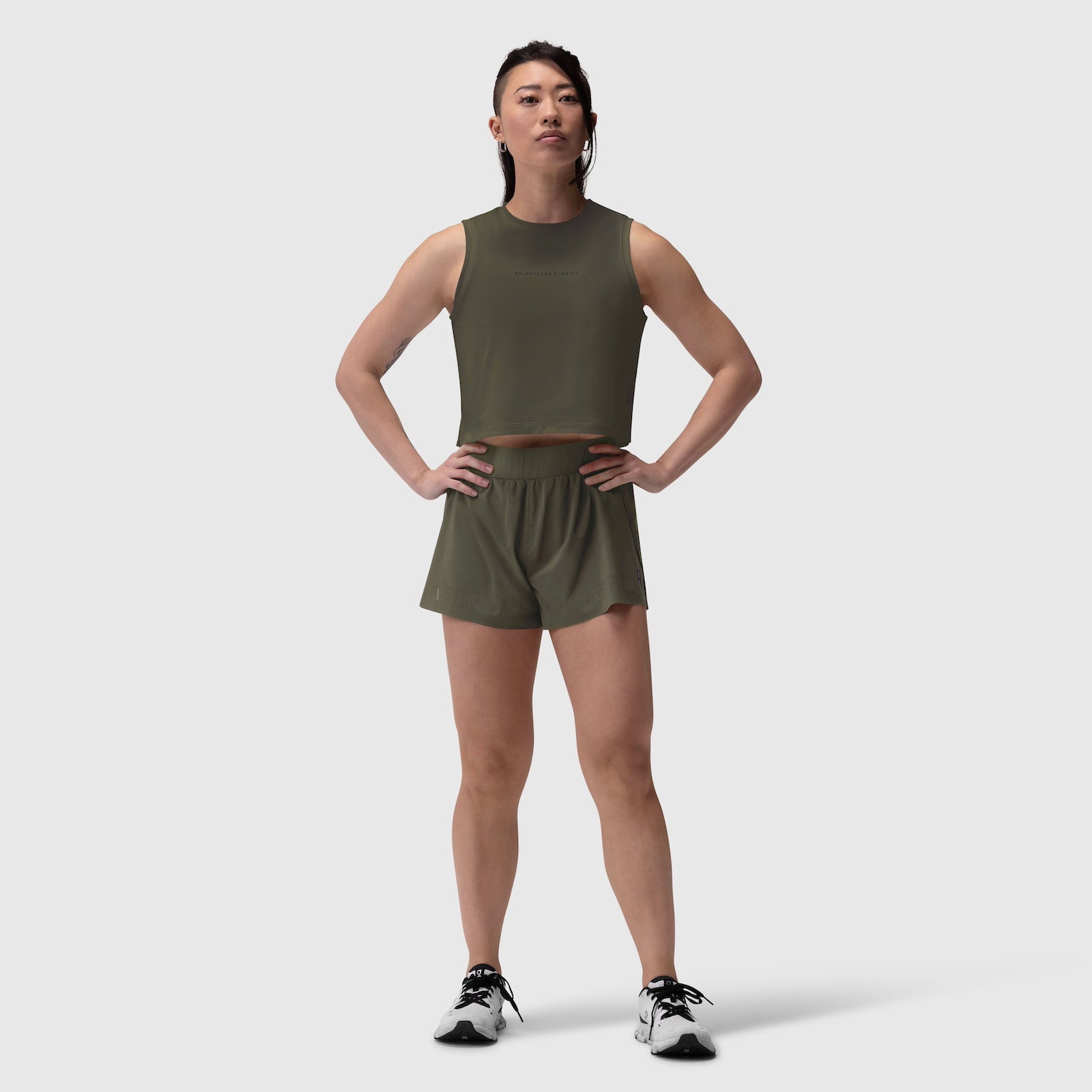 Aerotex Side Split Run Short in olive, worn by model standing front-facing