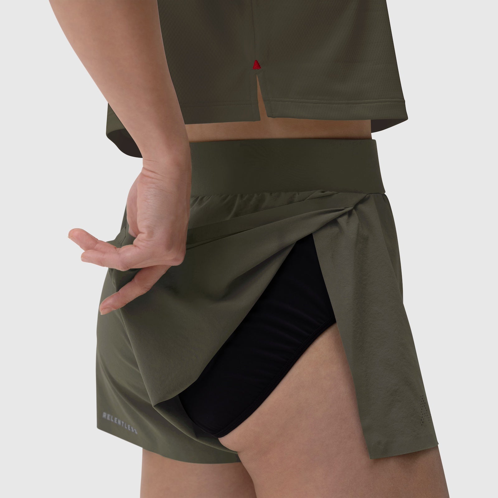 Aerotex Side Split Run Short in olive, worn by model showing side slit detail and black shorts underneath